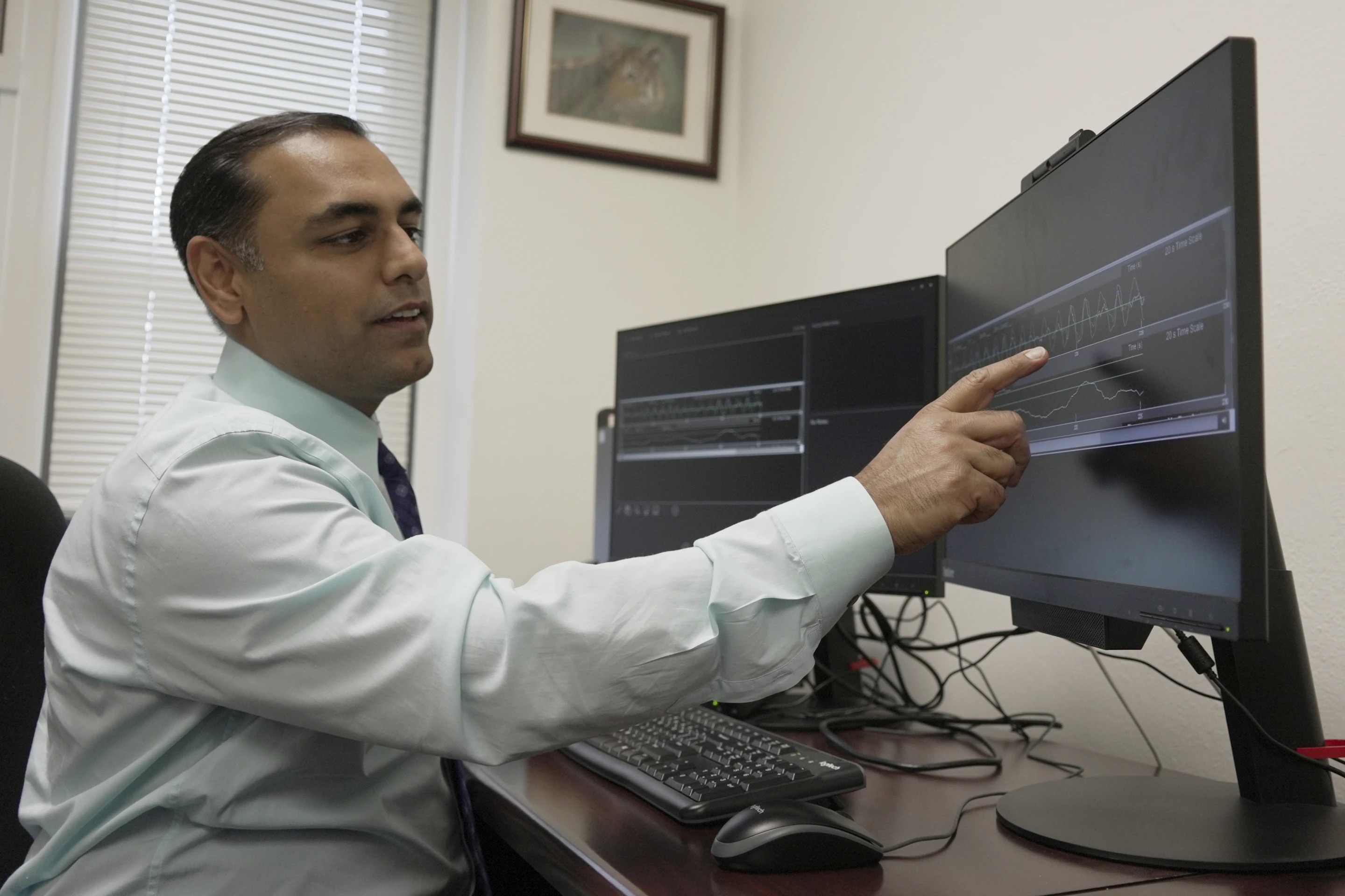 Dr. Roneil Malkani, assistant professor of neurology at Northwestern University Feinberg School of Medicine, shows an example of pink noise to slow brainwaves in deep sleep. 
