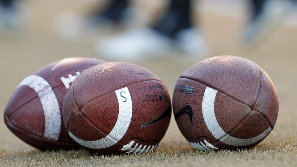 Footballs stand ready before the Virginia Tech at Wake Forest NCAA college football game in Winston-Salem, N.C., Saturday Oct. 15, 2011.