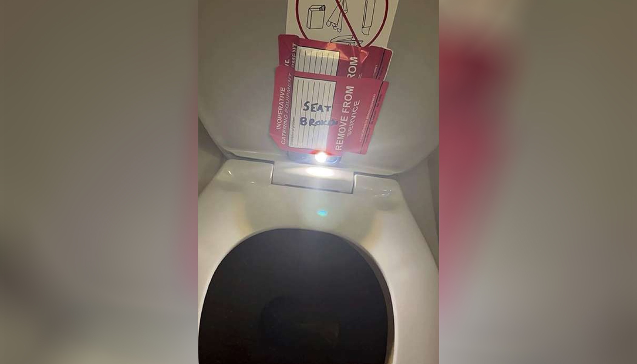 An iPhone taped to the back of a toilet seat on an American Airlines flight from Charlotte, N.C., to Boston, Sept. 2, 2023. An American Airlines flight attendant pleaded not guilty Monday to trying to record a 14-year-old female passenger.