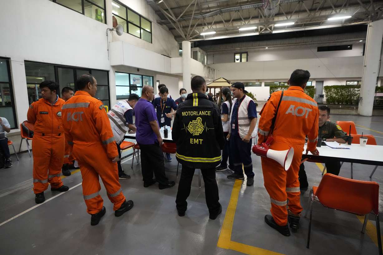 Members of a rescue team discuss after a London-Singapore flight was diverted to Bangkok due to severe turbulence, in Bangkok, Thailand, Tuesday.