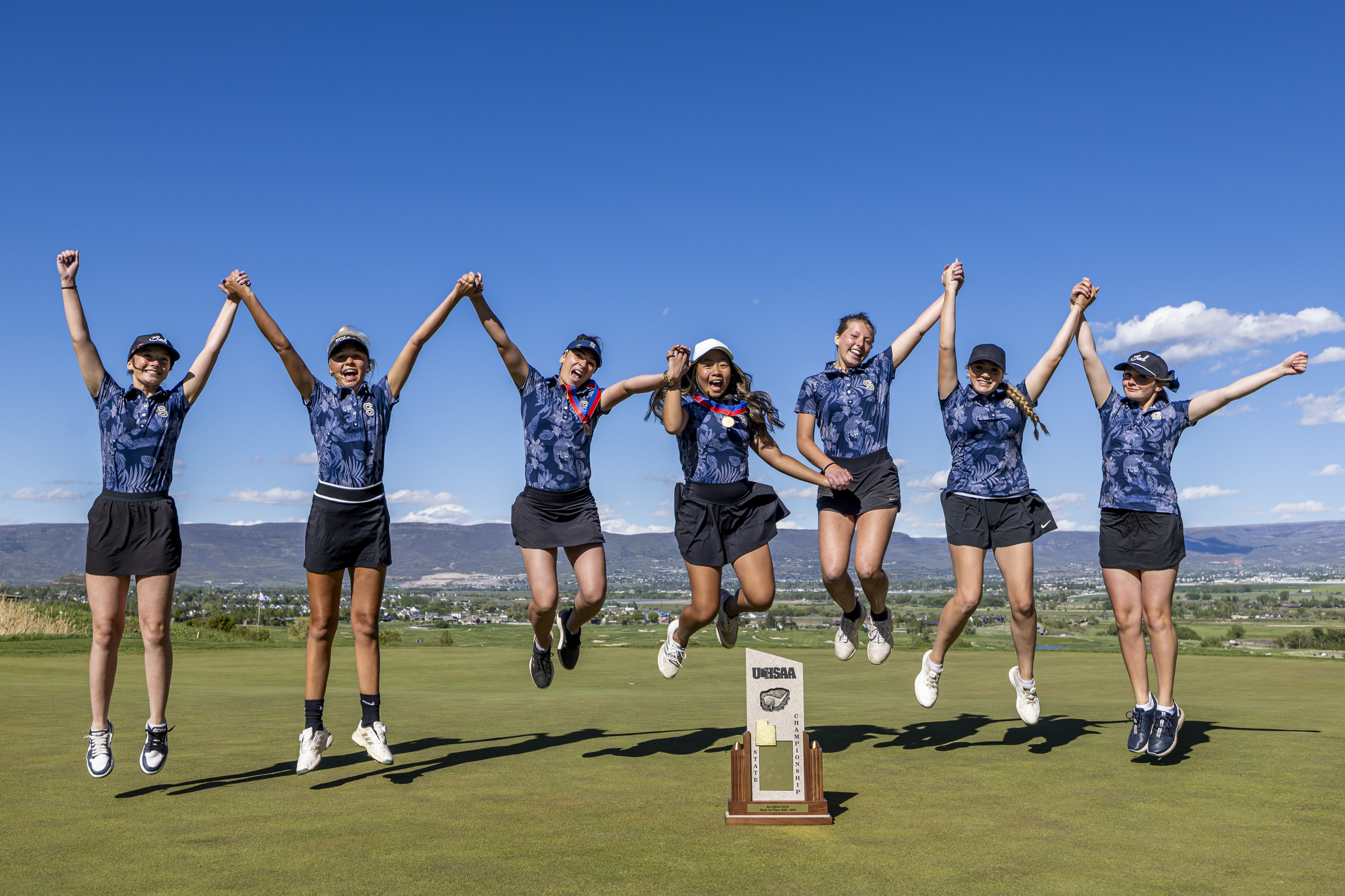 Skyline golfers celebrate with the championship trophy after the 5A girls golf high school championship held at Soldier Hollow Golf Course in Midway on Tuesday, May 21, 2024.