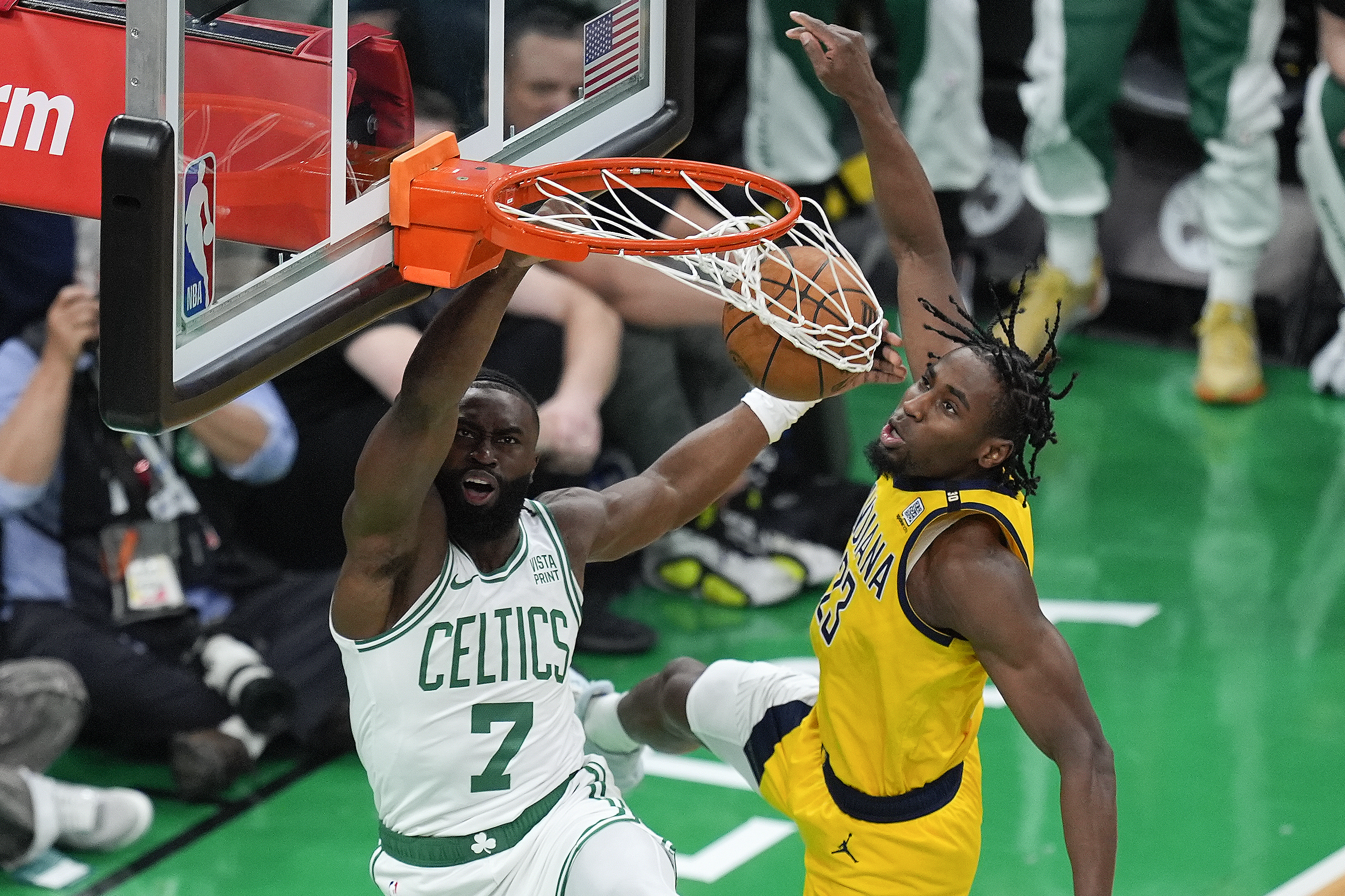 Boston Celtics guard Jaylen Brown (7) dunks the ball against Indiana Pacers forward Aaron Nesmith (23) during the first quarter of Game 1 of the NBA Eastern Conference basketball finals, Tuesday, May 21, 2024, in Boston.