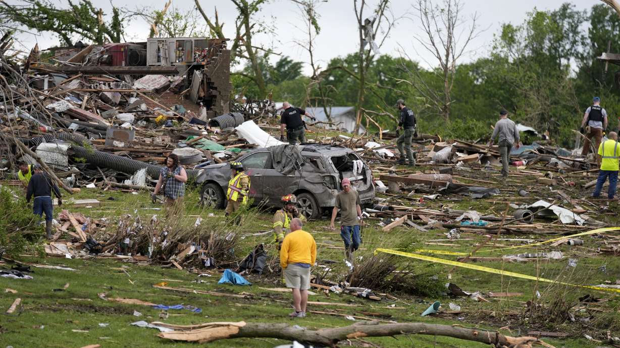 Workers search through the remains of tornado-damaged homes, Tuesday in Greenfield, Iowa.