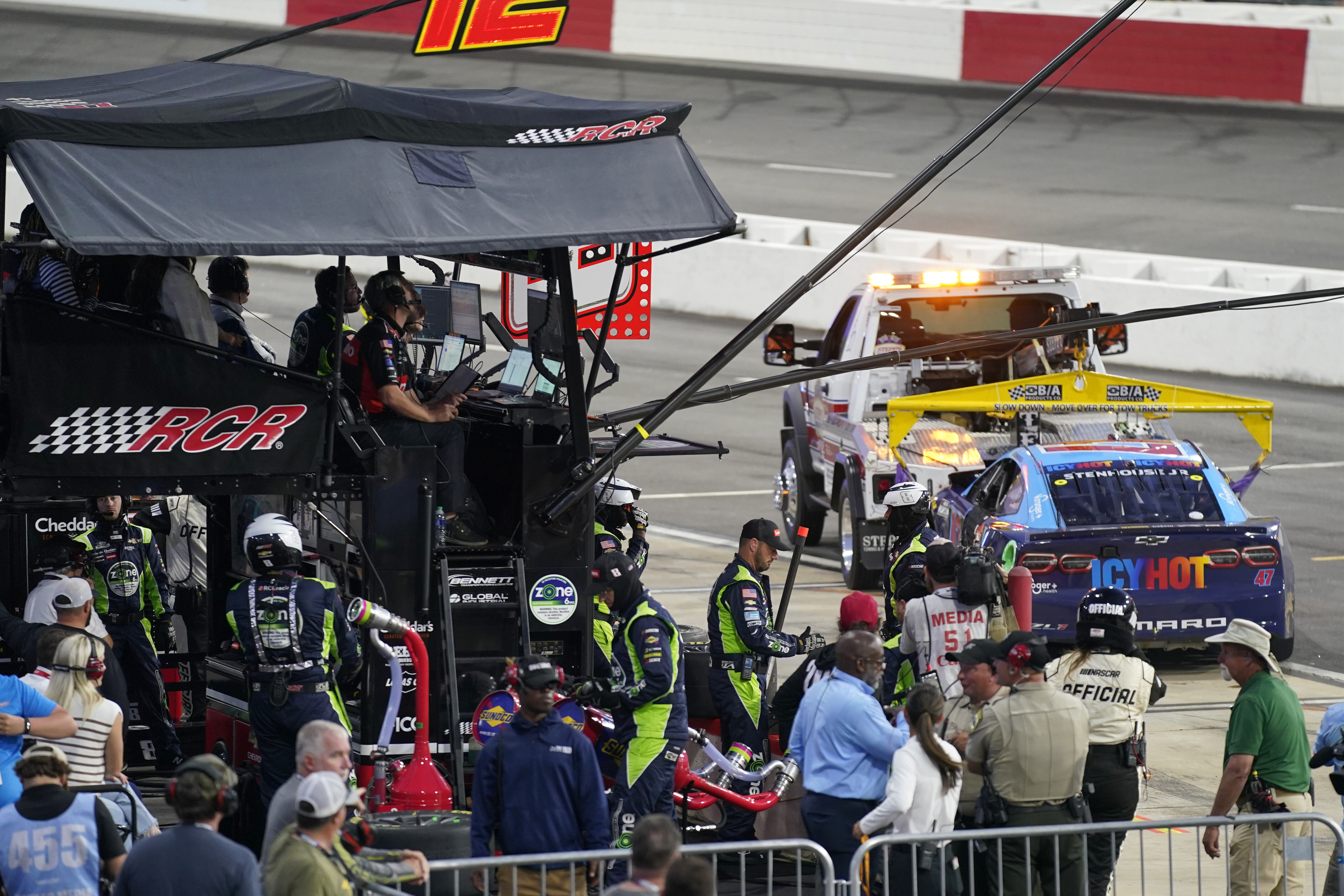 The car of Ricky Stenhouse Jr. is towed away from the pit of Kyle Busch during the NASCAR All-Star auto race at North Wilkesboro Speedway in North Wilkesboro, N.C., Sunday, May 19, 2024. Stenhouse crashed after contact with Busch and stopped his damaged car at Busch's team's pit. 