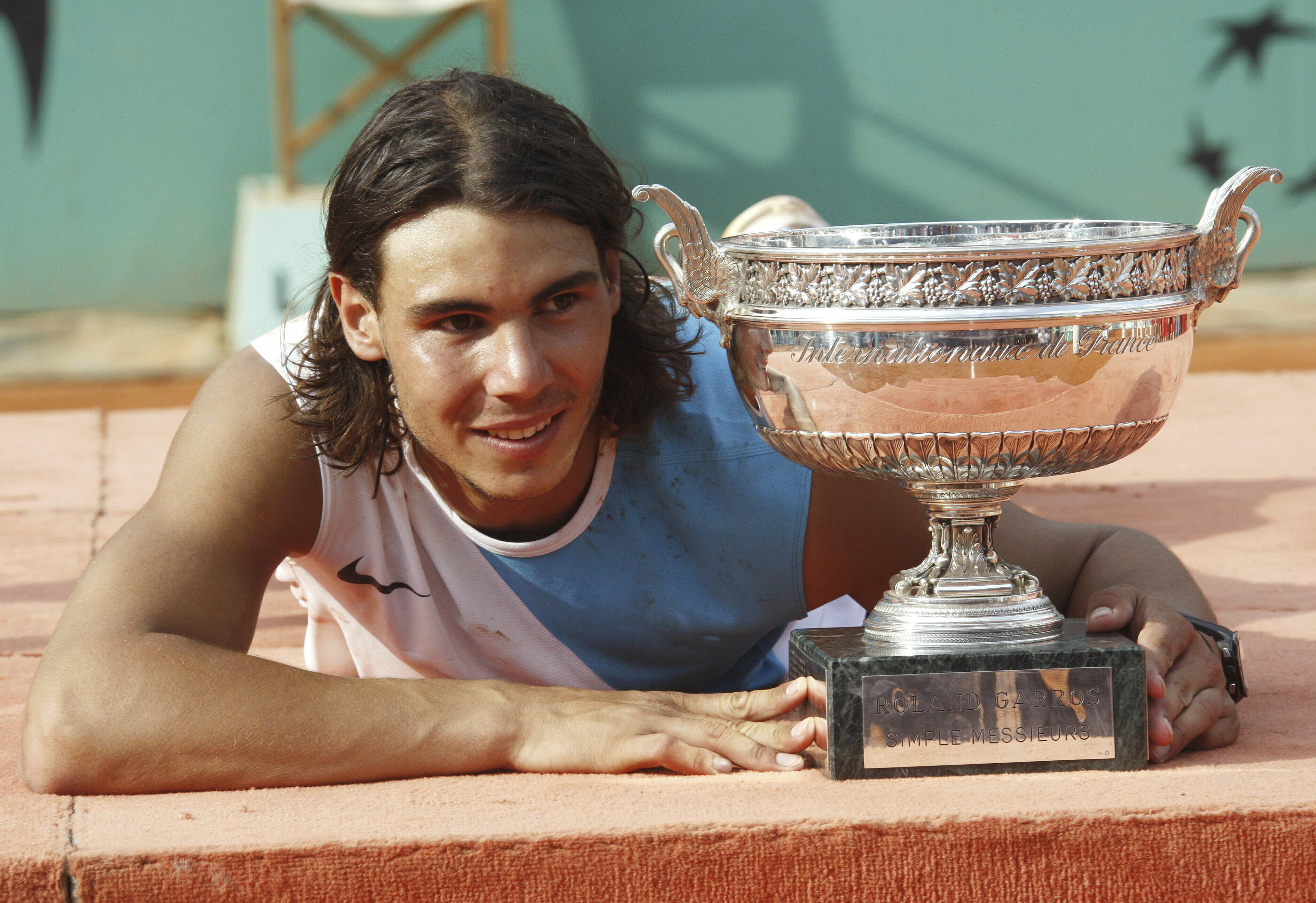 FILE - Spain's Rafael Nadal poses with the cup after defeating Switzerland's Roger Federer during the men's final match of the French Open tennis tournament at Roland Garros stadium in Paris, Sunday, June 10, 2007. Nadal won 6-3, 4-6, 6-3, 6-4.