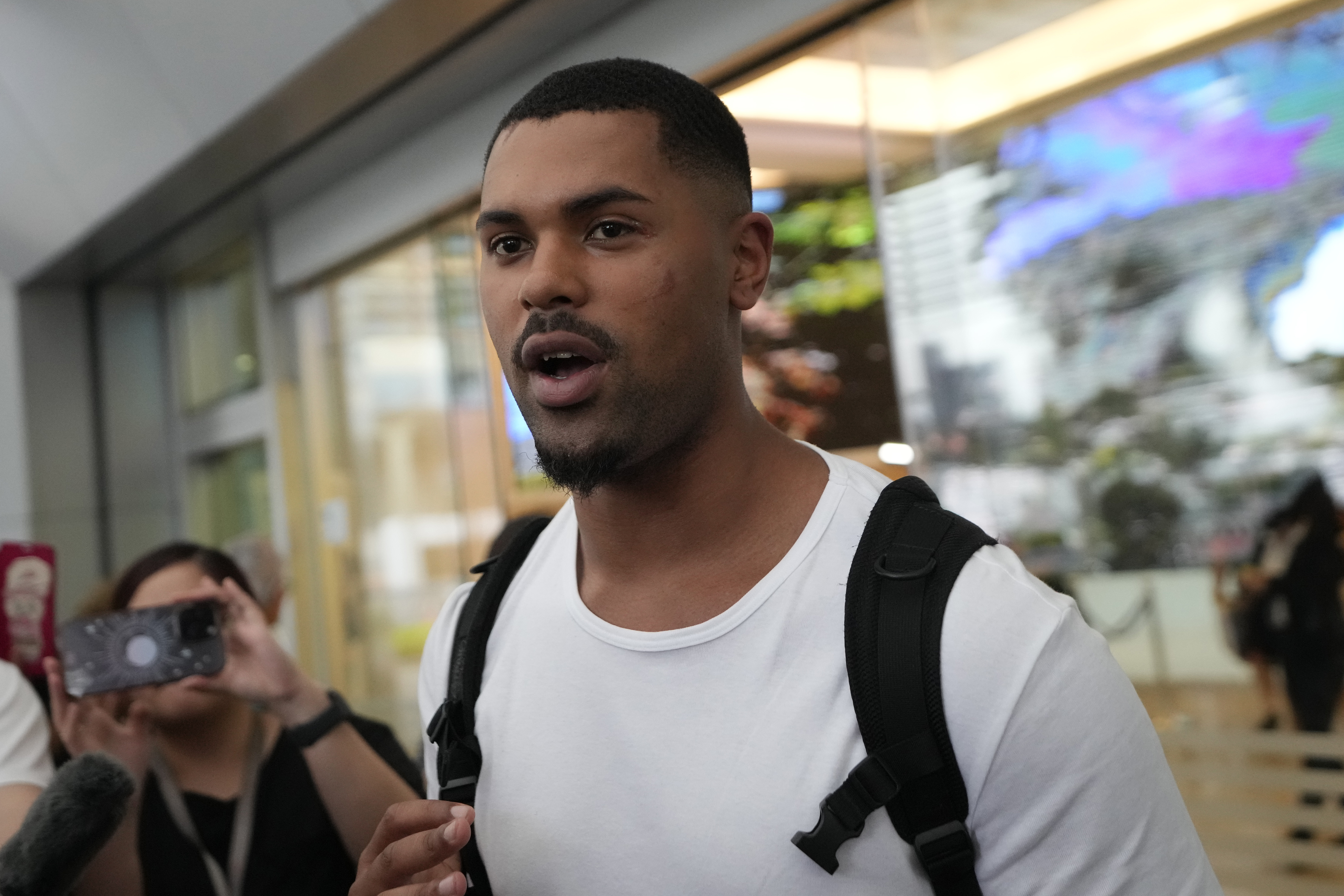 Josh Silverstone, from Britain, who was injured during the flight of the Singapore Airlines Boeing 777-300ER, talks to reporters at Samitivej Srinakarin Hospital, in Bangkok, Thailand, Wednesday. Several of the more seriously injured people from the flight that hit severe turbulence will need spinal surgery.
