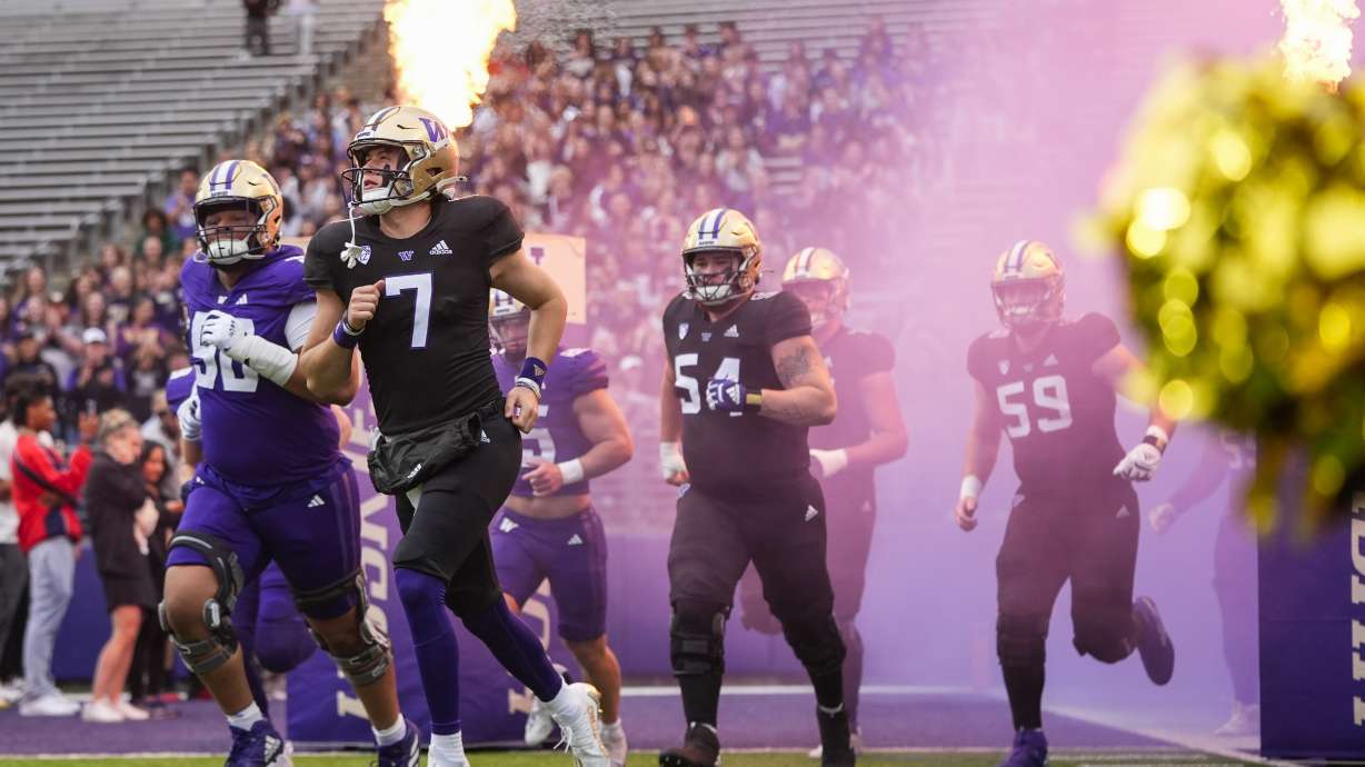 Washington football players, including quarterback Will Rogers III (7) run out to the field before the NCAA college football team's spring game Friday, May 3, 2024, in Seattle.