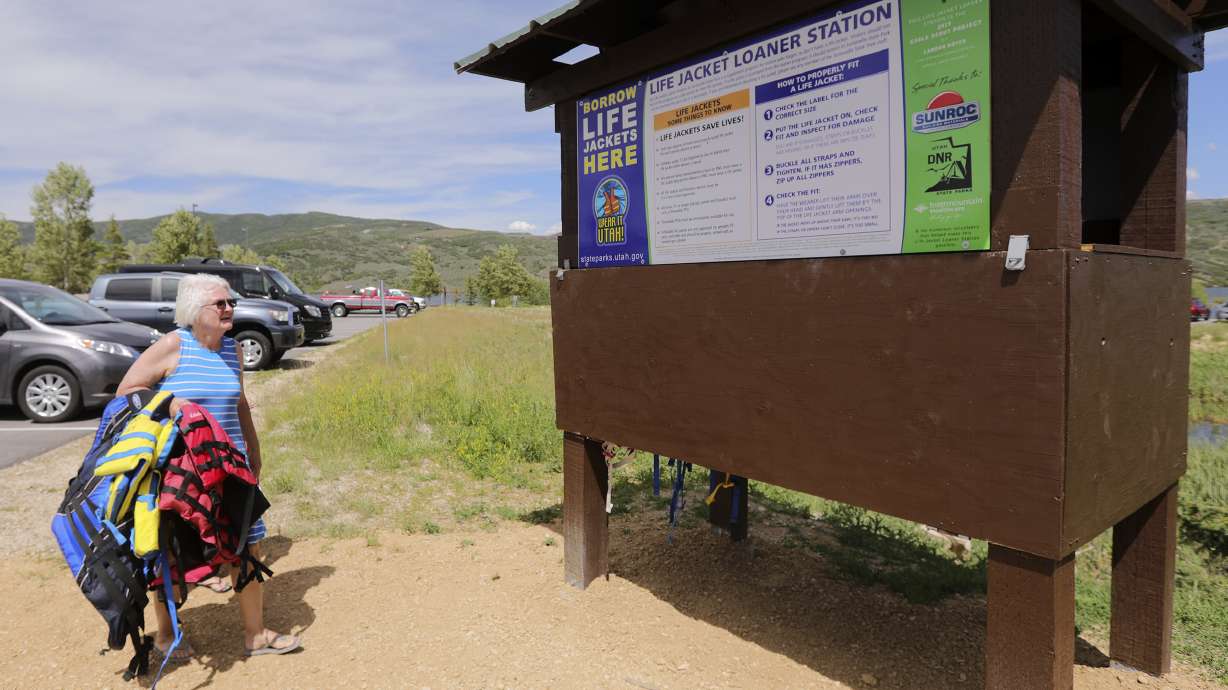 Carla Sharp returns life jackets to the life jacket loaner station after her grandchildren used them at Jordanelle State Park on June 26, 2019. Primary Children's Hospital Wednesday announced 900 life jackets were donated to such stations across Utah.