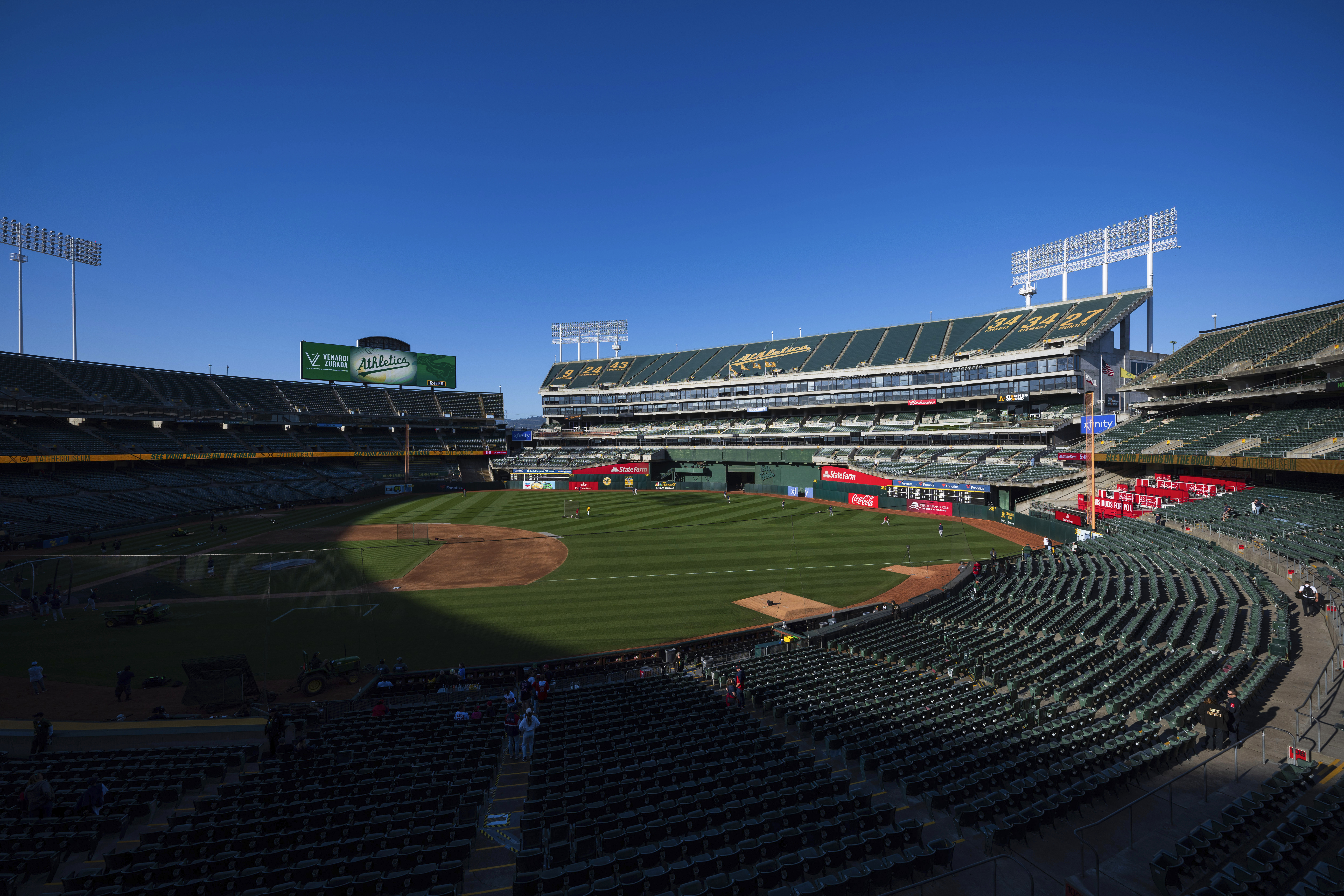 FILE - Fans walk to their seats before the start of a baseball game, April 2, 2024, in Oakland, Calif. The city of Oakland is selling its share of the Coliseum — home to the departing Oakland Athletics — to a local Black development group for at least $105 million, Mayor Sheng Thao announced Wednesday, May 22, 2024. 