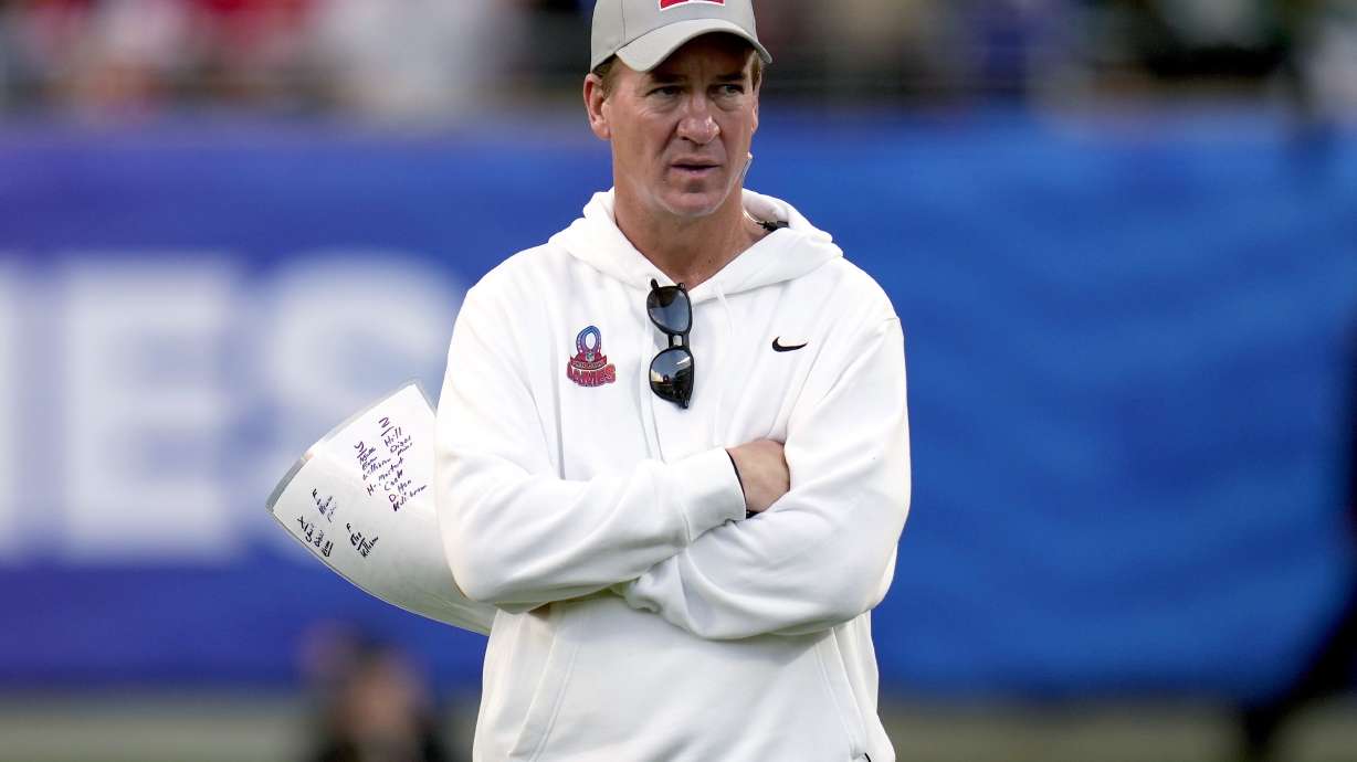 FILE - AFC coach Peyton Manning watches during the flag football event at the NFL Pro Bowl football game Feb. 4, 2024, in Orlando, Fla. Eight years into retirement, Manning said Wednesday, May 22, he still has no desire to run a franchise, insisting he gets his football fix by working with brother Eli on ManningCast, the alternative live broadcasts of Monday Night Football.