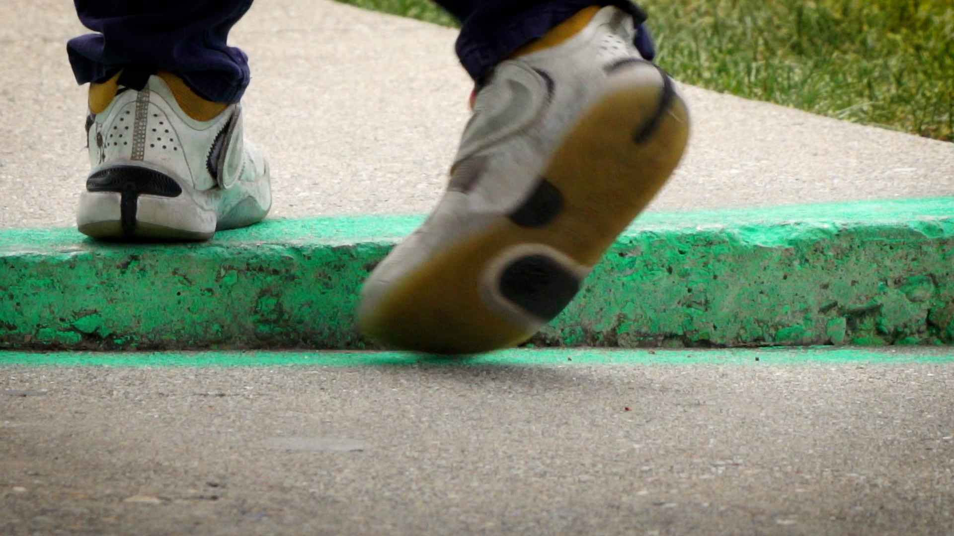 A student steps over a ledge in the sidewalk on Navajo Street on Salt Lake City’s west side.