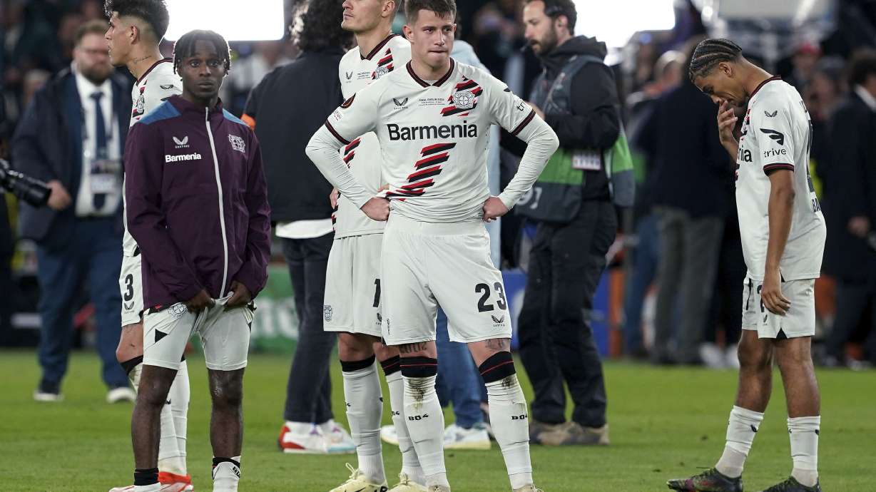 Bayer Leverkusen's Jeremie Frimpong, Adam Hlozek and Amine Adli, from left, react after the team's Europa League final against Atalanta on Wednesday May 22, 2024, in Dublin, Ireland. The record-setting run of Bayer Leverkusen is over at 51.