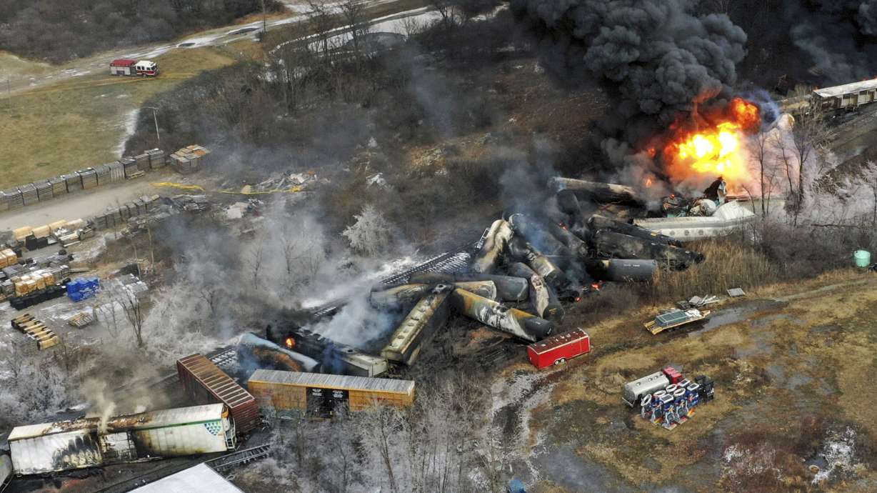 Debris from a Norfolk Southern freight train lies scattered and burning along the tracks on Feb. 4, 2023, the day after it derailed in East Palestine, Ohio.