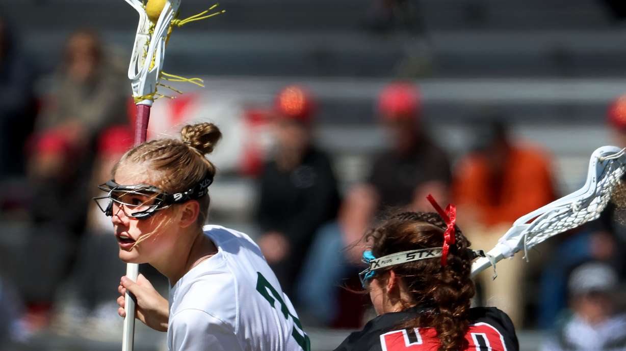 Olympus’ Hannah Nelson keeps the ball from Park City’s Maddie McHenry in the 5A girls lacrosse championship game at Zions Bank Stadium in Herriman on Thursday, May 23, 2024.