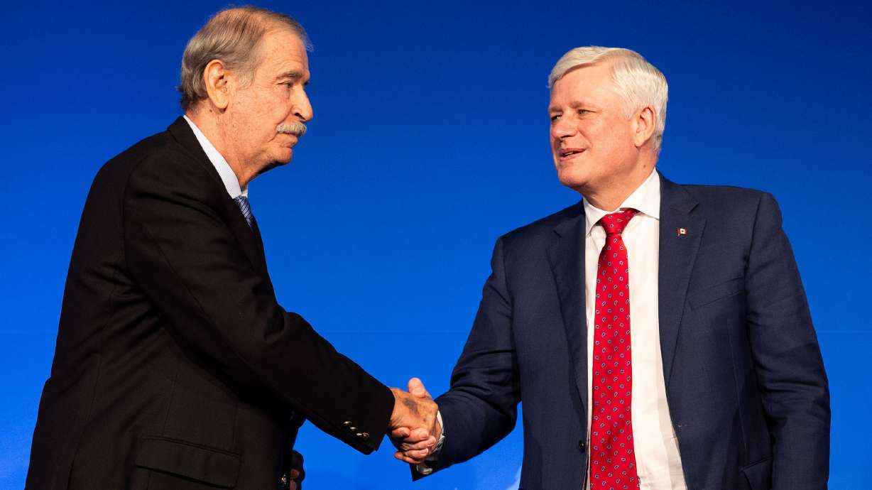 From left, former Mexican President Vicente Fox shakes hands with former Canadian Prime Minister Stephen Harper at the Crossroads of the World International Trade Summit at the Grand America Hotel in Salt Lake City on Thursday.