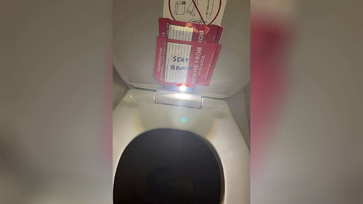 An iPhone is taped to the back of a toilet seat on an American Airlines flight from Charlotte, N.C., to Boston, Sept. 2, 2023. Estes Carter Thompson III, an American Airlines flight attendant, pleaded not guilty Monday.
