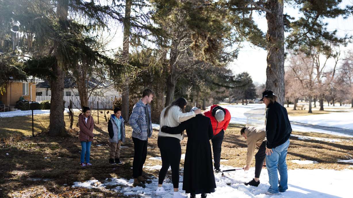 The family of Jordan Rasmussen gathers at Wasatch Lawn Memorial Park and Mortuary in Millcreek on Sunday, March 5, 2023.