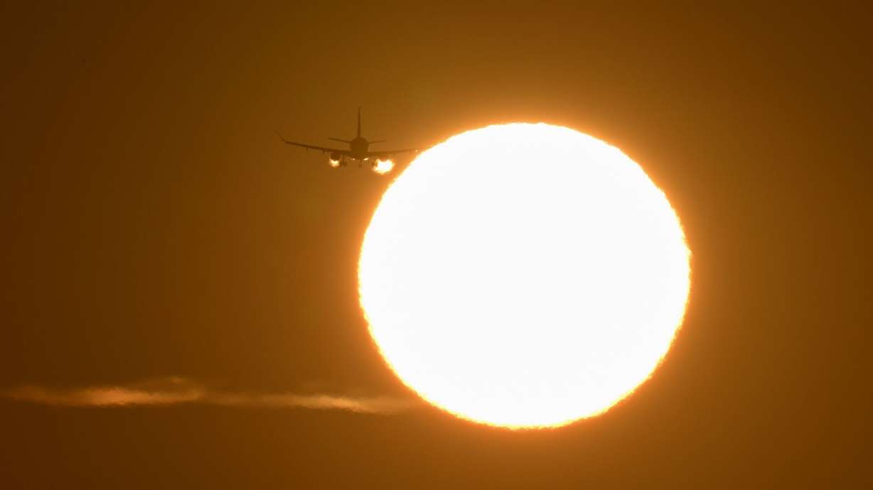 A plane arrives at San Francisco International Airport during sunset on May 15. Much of the country is forecast to have higher-than-average temperatures this summer. That could affect flights depending on how hot it gets.
