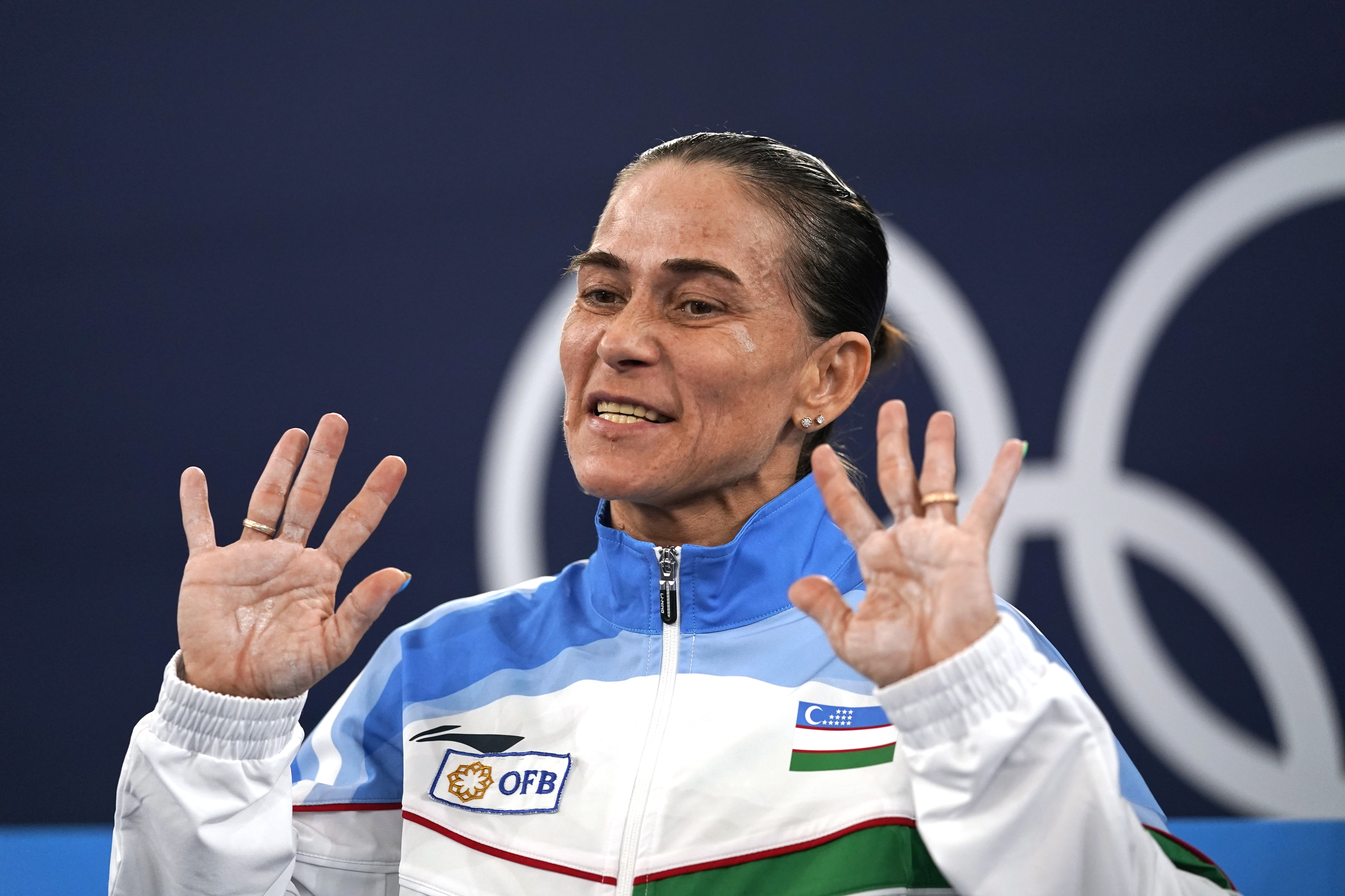 FILE - Oksana Chusovitina of Uzbekistan gestures after performing on the vault during the women's artistic gymnastic qualifications, her eighth Olympics participation, at the 2020 Summer Olympics in Tokyo, on July 25, 2021. Record-breaking 48-year-old gymnast Oksana Chusovitina says an injury has ended her attempt to qualify for what would have been her ninth Olympics.