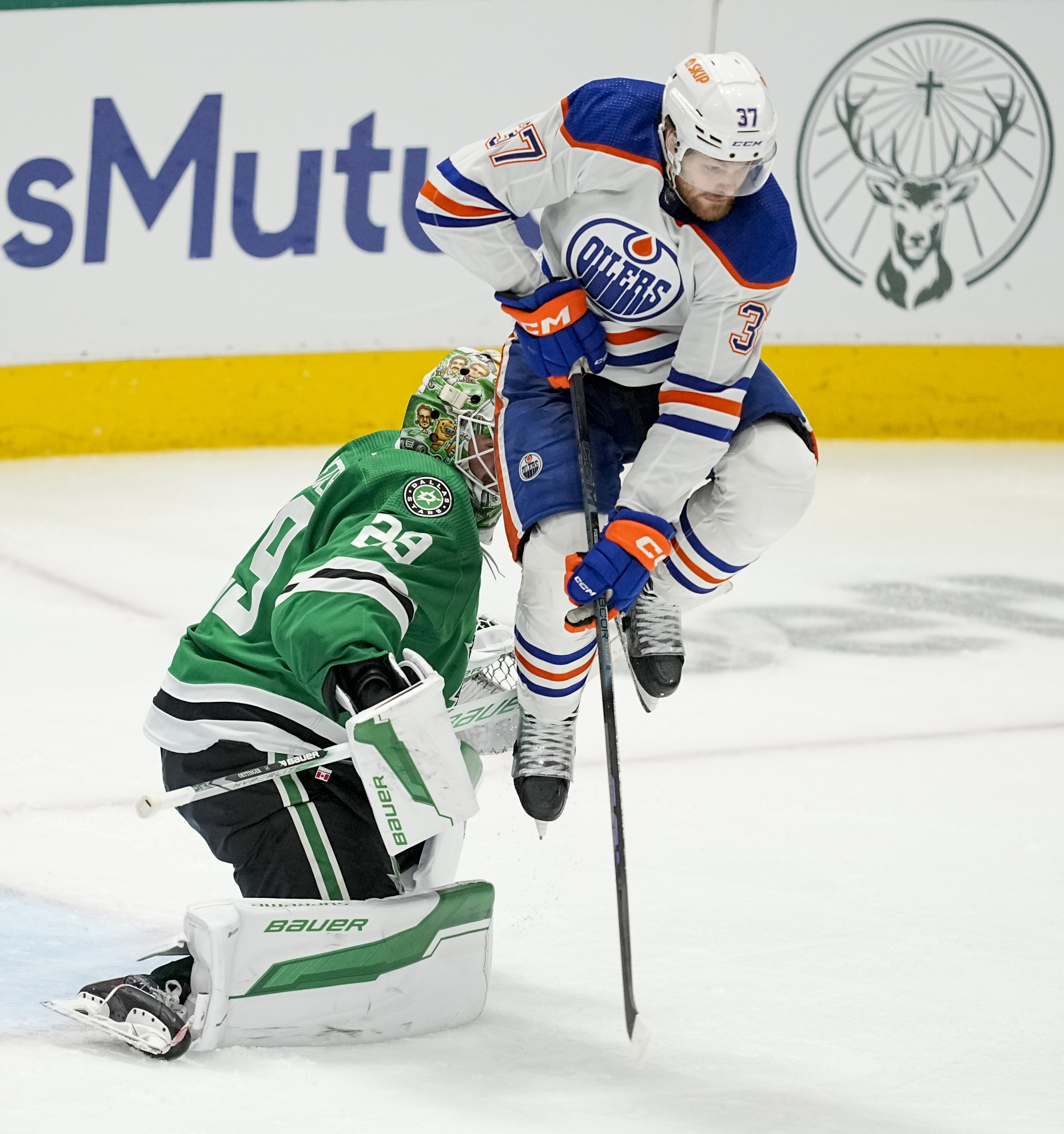 Dallas Stars goaltender Jake Oettinger (29) makes a save as Edmonton Oilers left wing Warren Foegele (37) applies a screen during overtime in Game 1 of the NHL hockey Western Conference Stanley Cup playoff finals, Thursday, May 23, 2024, in Dallas. 