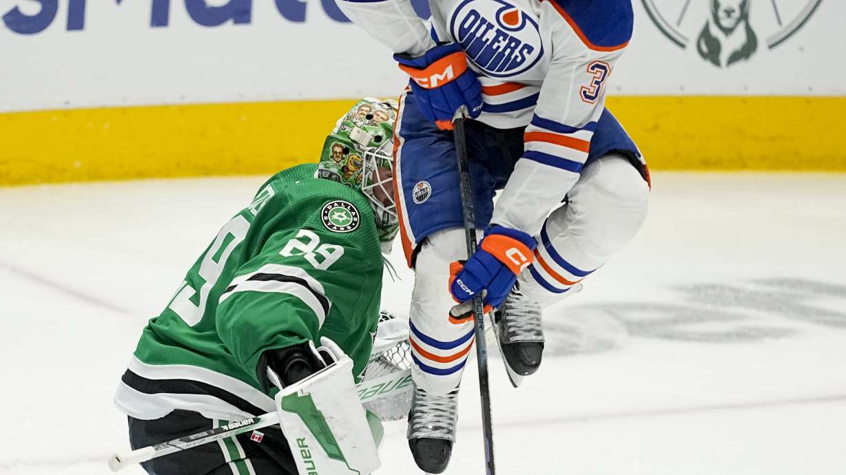 Dallas Stars goaltender Jake Oettinger (29) makes a save as Edmonton Oilers left wing Warren Foegele (37) applies a screen during overtime in Game 1 of the NHL hockey Western Conference Stanley Cup playoff finals, Thursday, May 23, 2024, in Dallas.