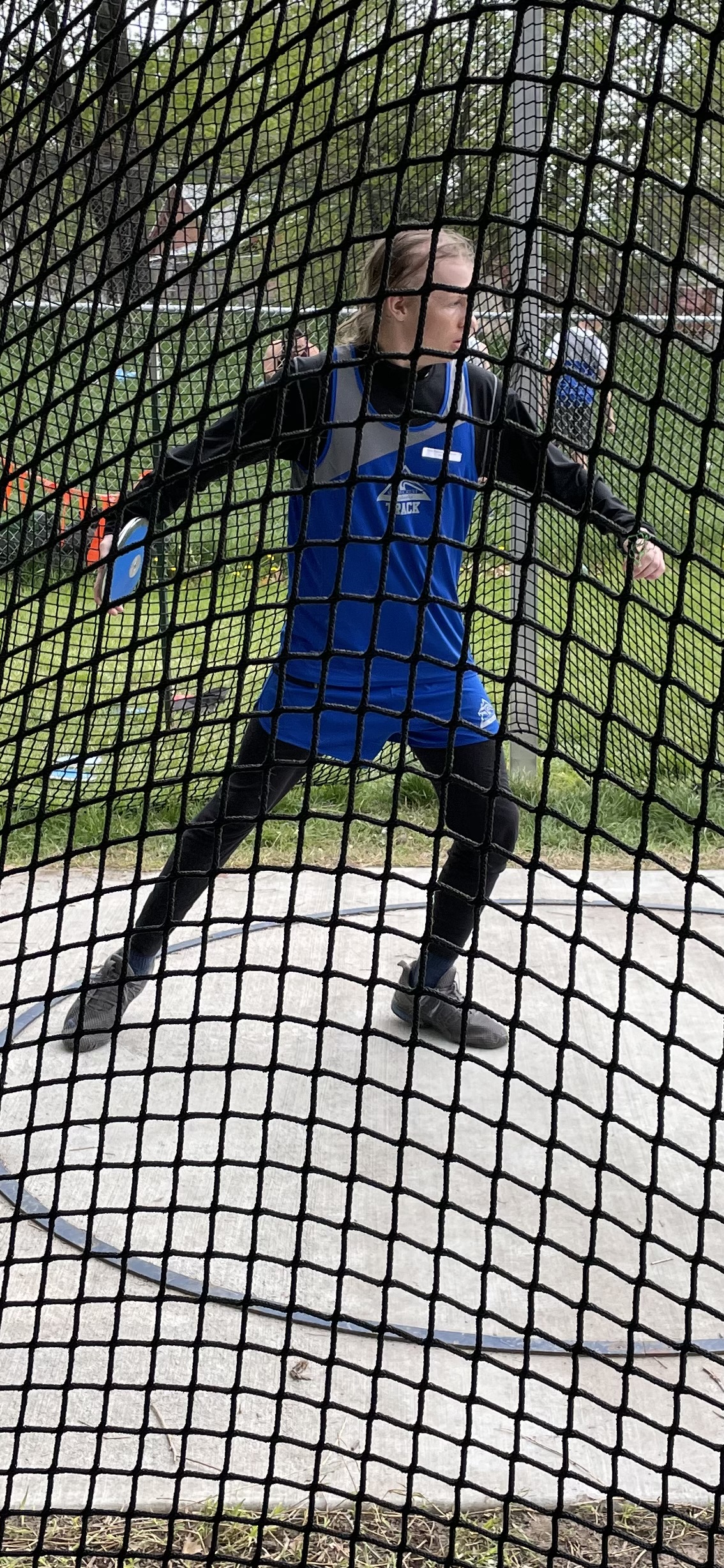 Alden Peterson, who is in remission from brain cancer, throws the discus at a recent track meet.