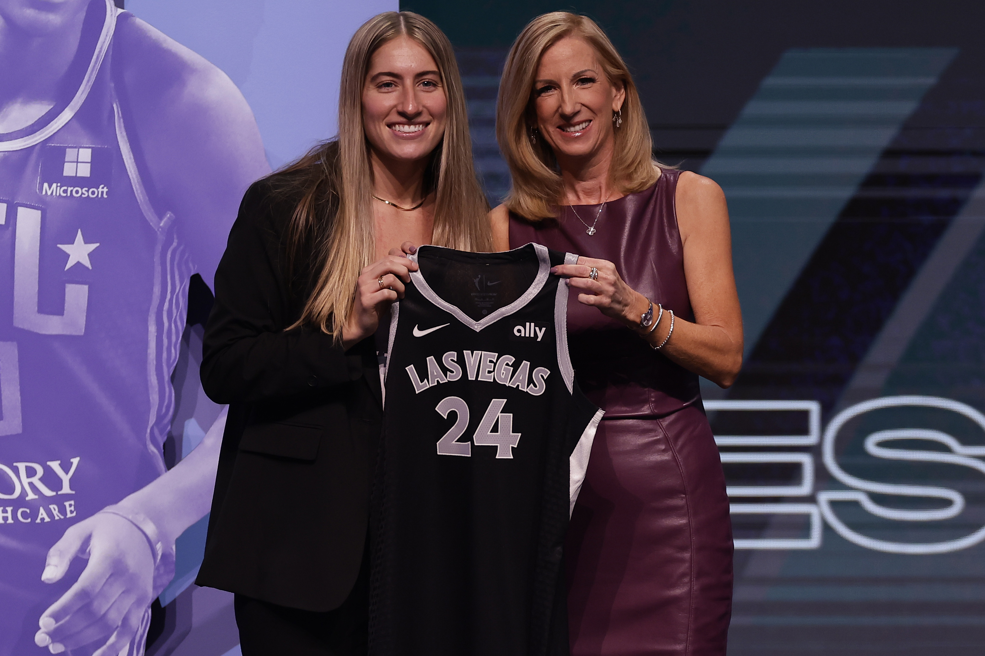FILE - Iowa's Kate Martin, left, poses for a photo with WNBA commissioner Cathy Engelbert, right, after being selected 18th overall by the Las Vegas Aces during the second round of the WNBA basketball draft April 15, 2024, in New York. Former Iowa player Martin made the Aces opening day roster after being chosen in the second round of the WNBA draft. 