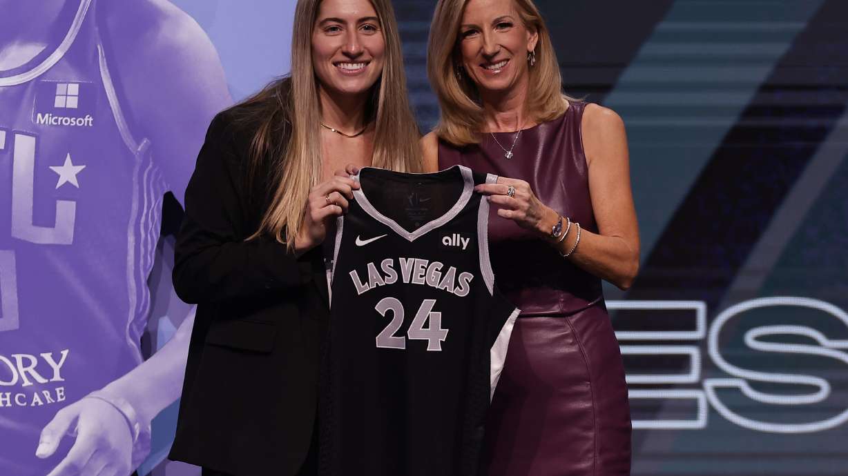 FILE - Iowa's Kate Martin, left, poses for a photo with WNBA commissioner Cathy Engelbert, right, after being selected 18th overall by the Las Vegas Aces during the second round of the WNBA basketball draft April 15, 2024, in New York. Former Iowa player Martin made the Aces opening day roster after being chosen in the second round of the WNBA draft.
