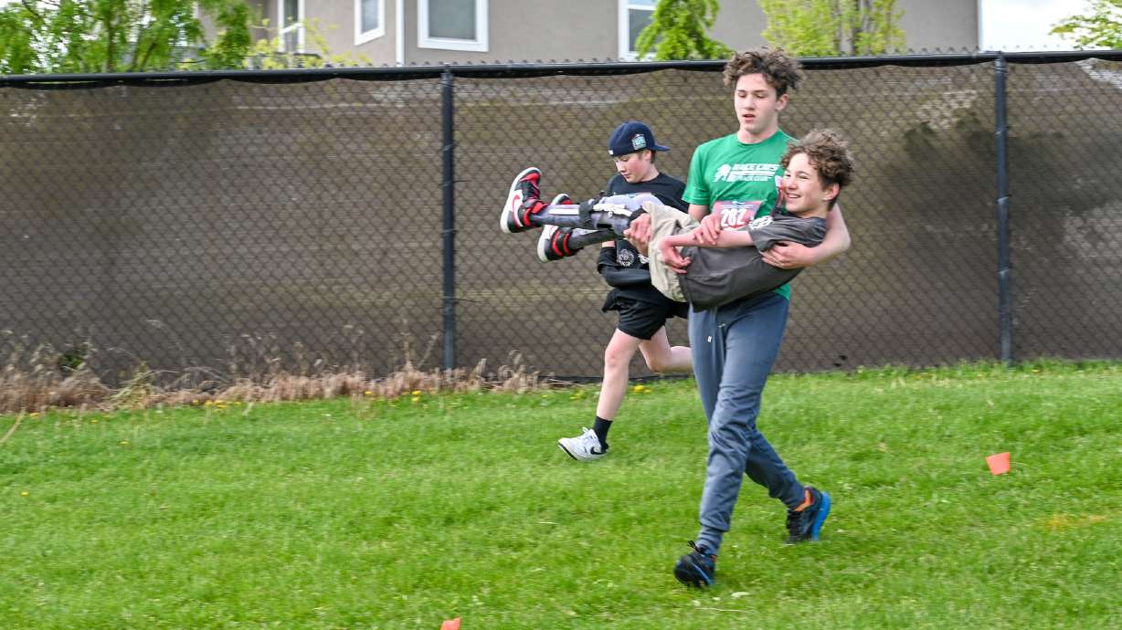 A seventh grader is being praised for helping his friend cross the finish line at their school race on Thursday.