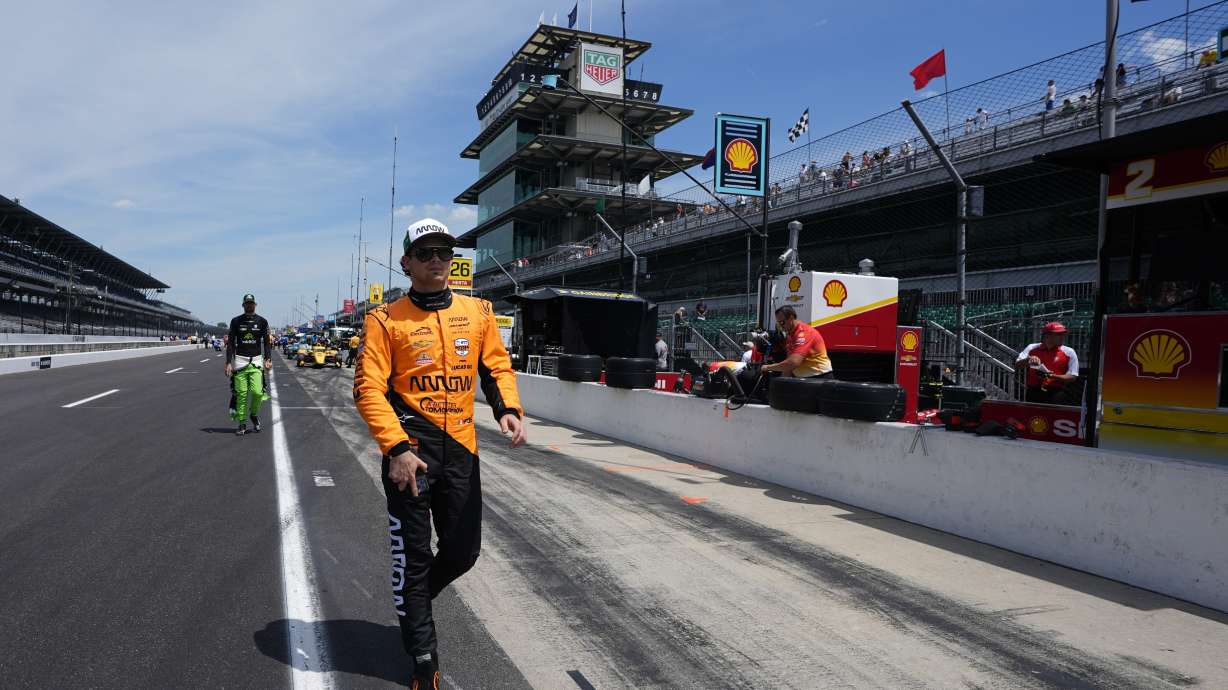 Pato O'Ward, of Mexico, walk down pit lane during a practice session for the Indianapolis 500 auto race at Indianapolis Motor Speedway, Monday, May 20, 2024, in Indianapolis.