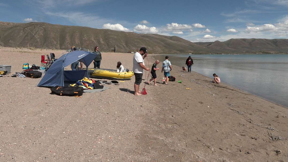 Rebecca Hrabar's family plays on the Bear Lake beach on Friday. The popular summer vacation spot will have much less beach room this holiday weekend because water levels are so high.
