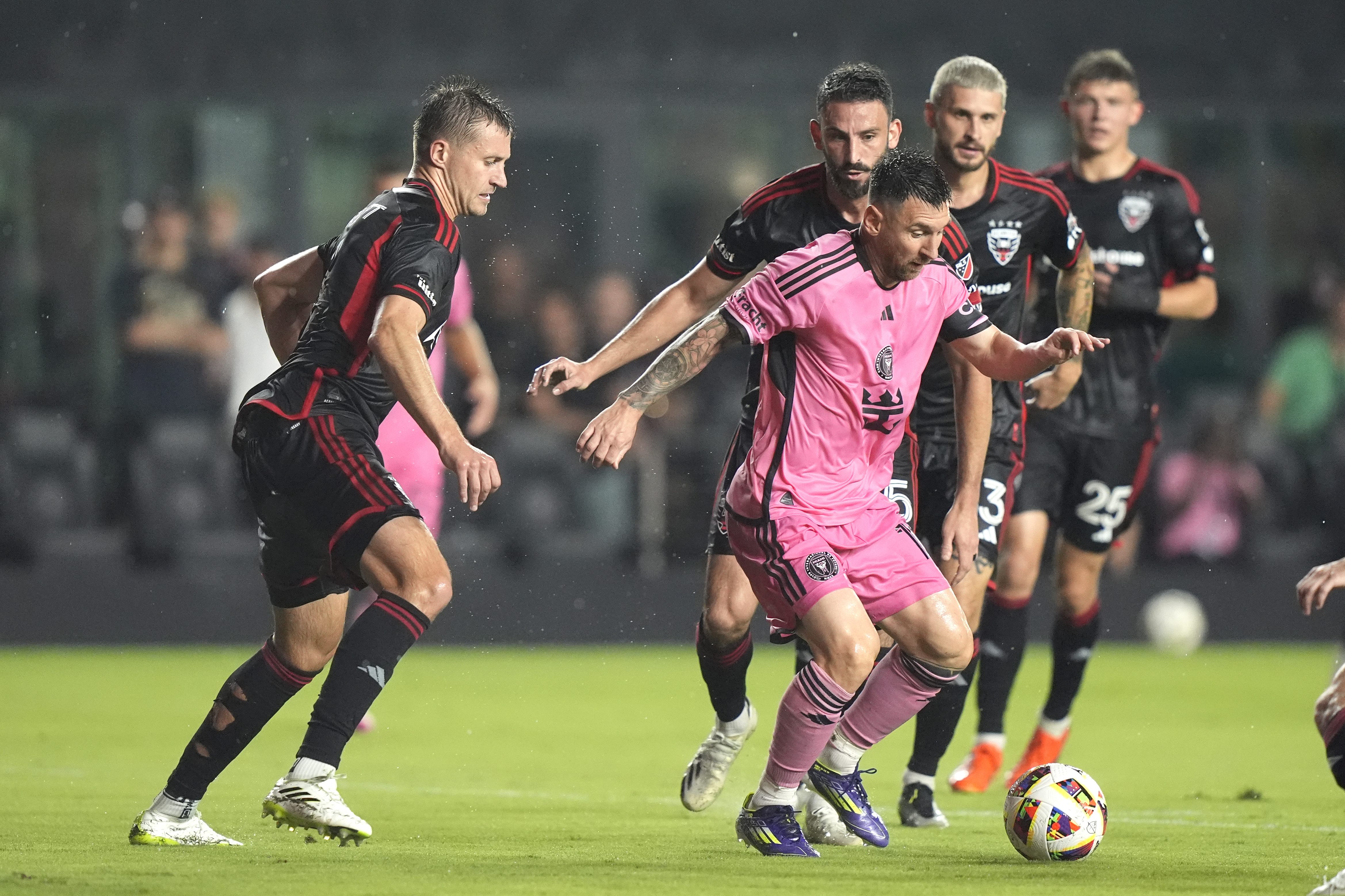 Inter Miami forward Lionel Messi, center, tries to control the ball during the first half of an MLS soccer match against D.C. United, Saturday, May 18, 2024, in Fort Lauderdale, Fla. 