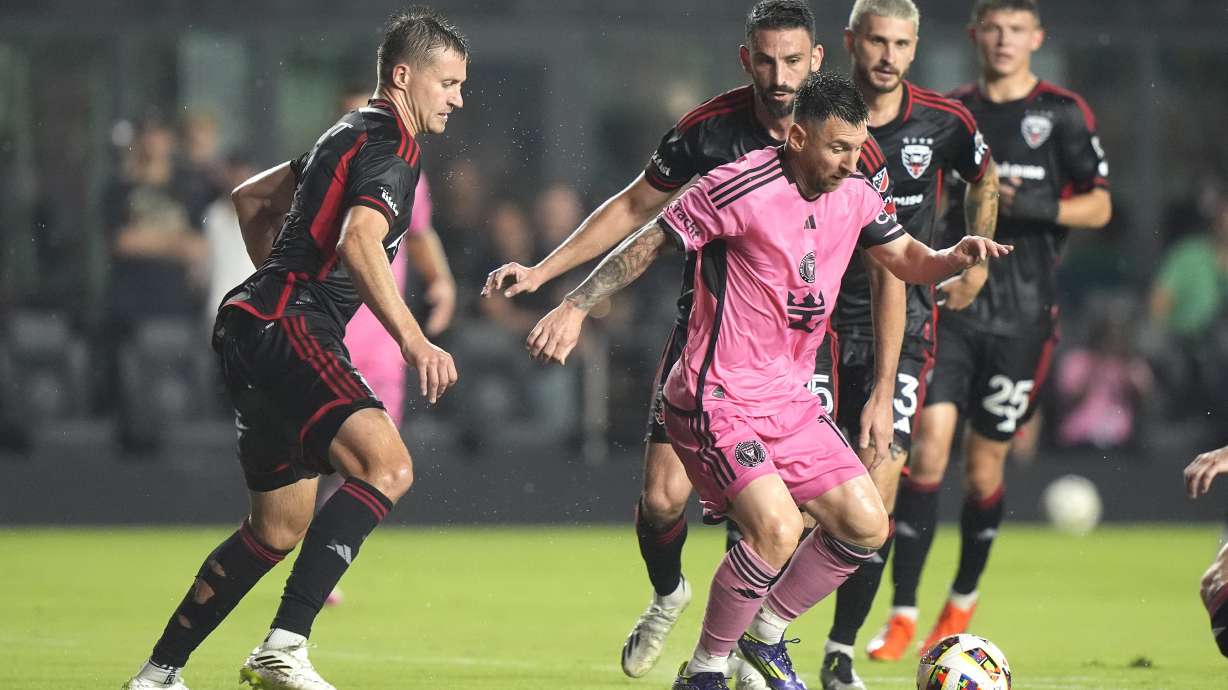 Inter Miami forward Lionel Messi, center, tries to control the ball during the first half of an MLS soccer match against D.C. United, Saturday, May 18, 2024, in Fort Lauderdale, Fla.
