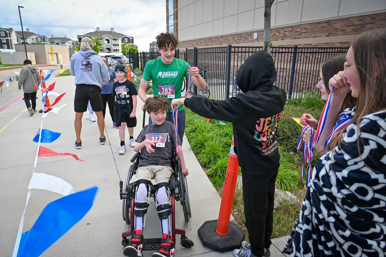 A seventh grader is being praised for helping his friend cross the finish line at their school race on Thursday.