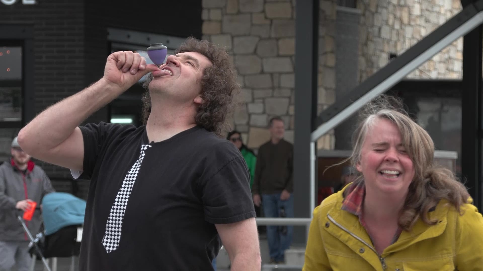 Busker Marcus Wilson spinning a top on his tongue.