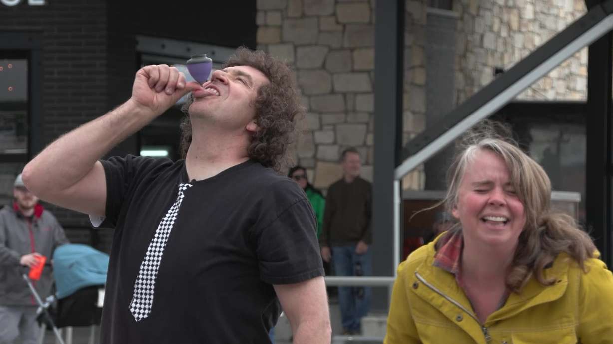 Busker Marcus Wilson spinning a top on his tongue.