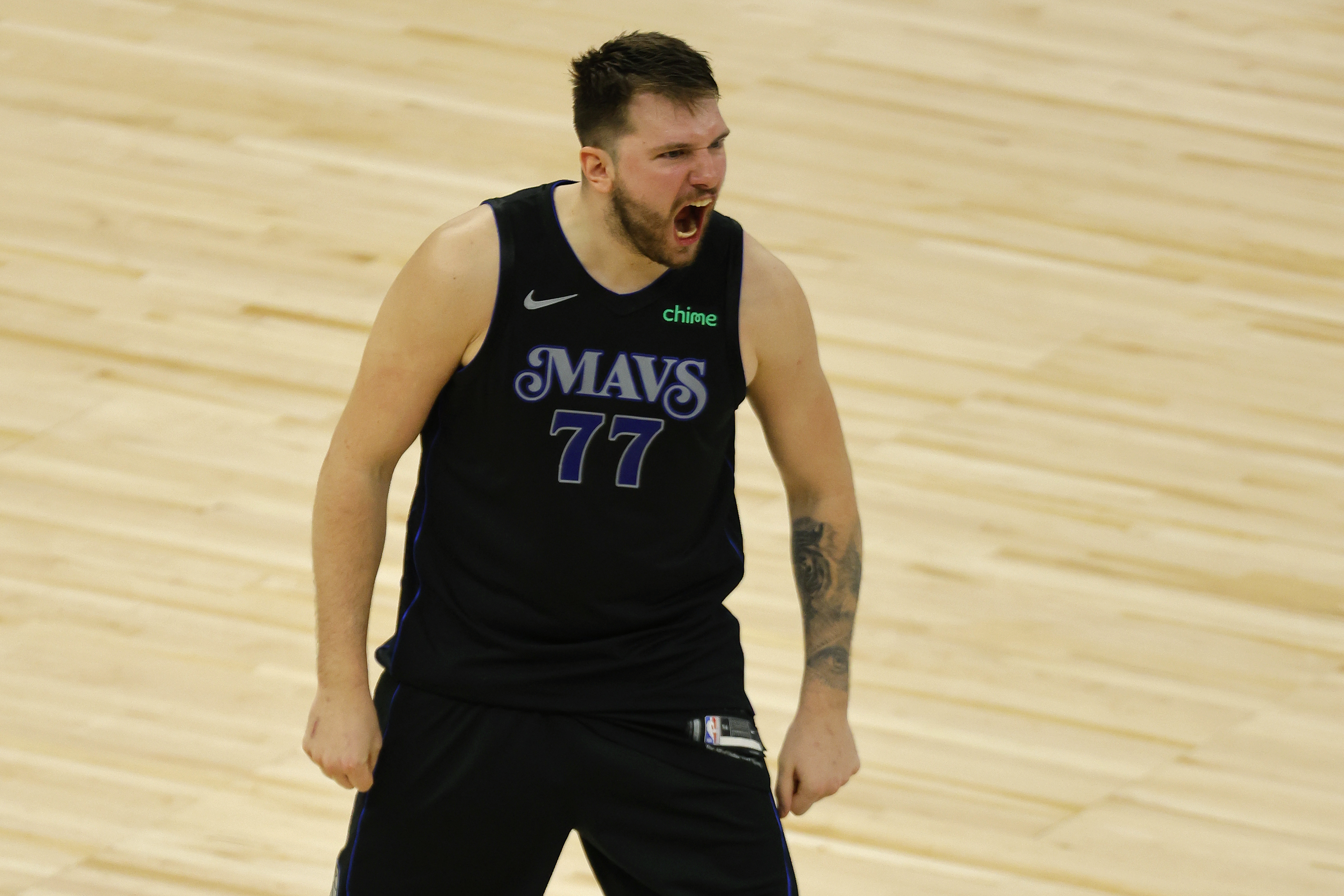 Dallas Mavericks guard Luka Doncic (77) celebrates after making a 3-point shot to take the lead against the Minnesota Timberwolves with seconds left during the second half of Game 2 of the NBA basketball Western Conference finals, Friday, May 24, 2024, in Minneapolis. 