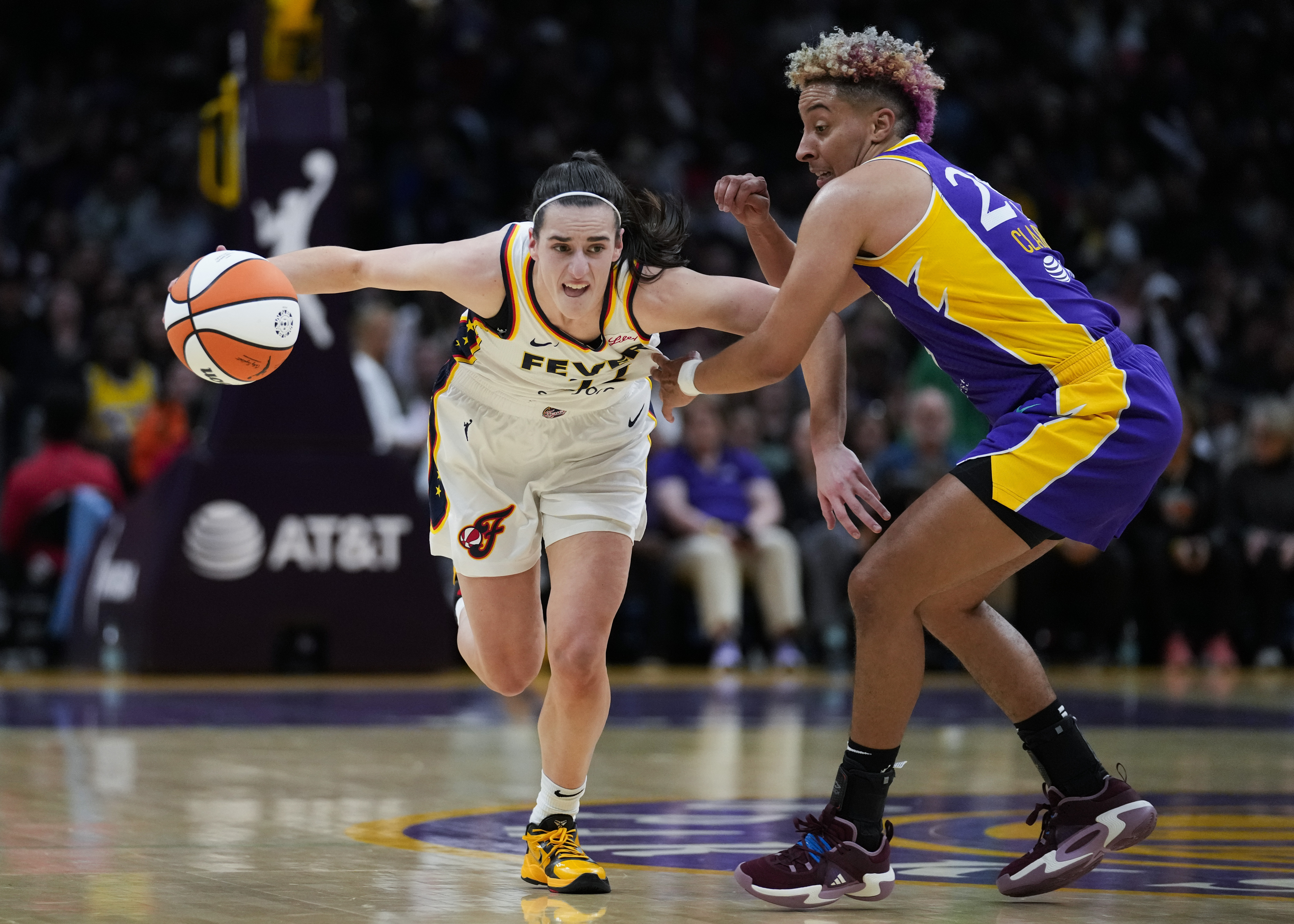 Los Angeles Sparks guard Layshia Clarendon, right, defends against Indiana Fever guard Caitlin Clark (22) during the first half of a WNBA basketball game in Los Angeles, Friday, May 24, 2024. 