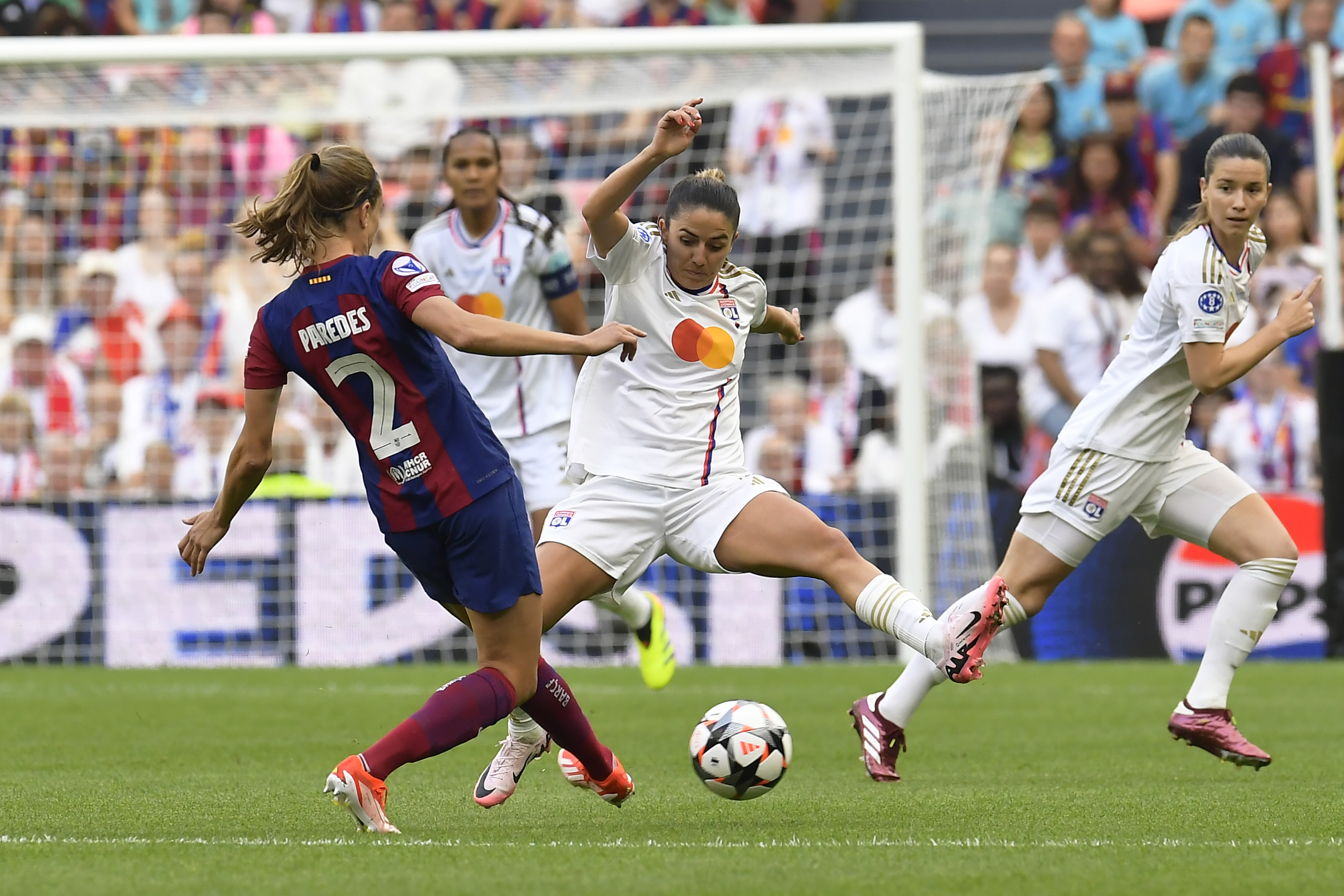 Lyon's Delphine Cascarino tries to block a shot from Barcelona's Irene Paredes, left, during the women's Champions League final soccer match between FC Barcelona and Olympique Lyonnais at the San Mames stadium in Bilbao, Spain, Saturday, May 25, 2024. 