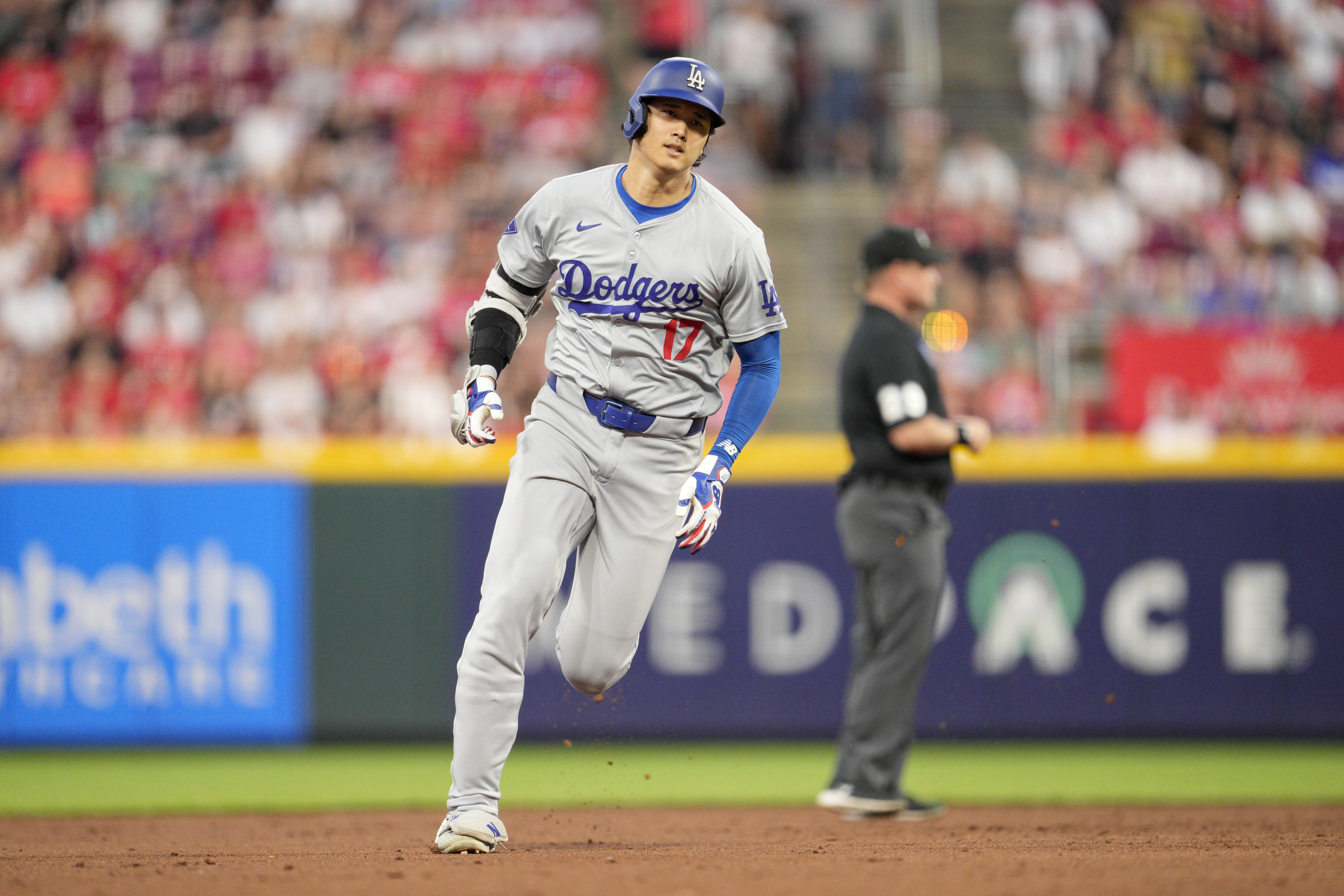 Los Angeles Dodgers' Shohei Ohtani rounds the bases after hitting a triple during the sixth inning of a baseball game against the Cincinnati Reds, Saturday, May 25, 2024, in Cincinnati. 