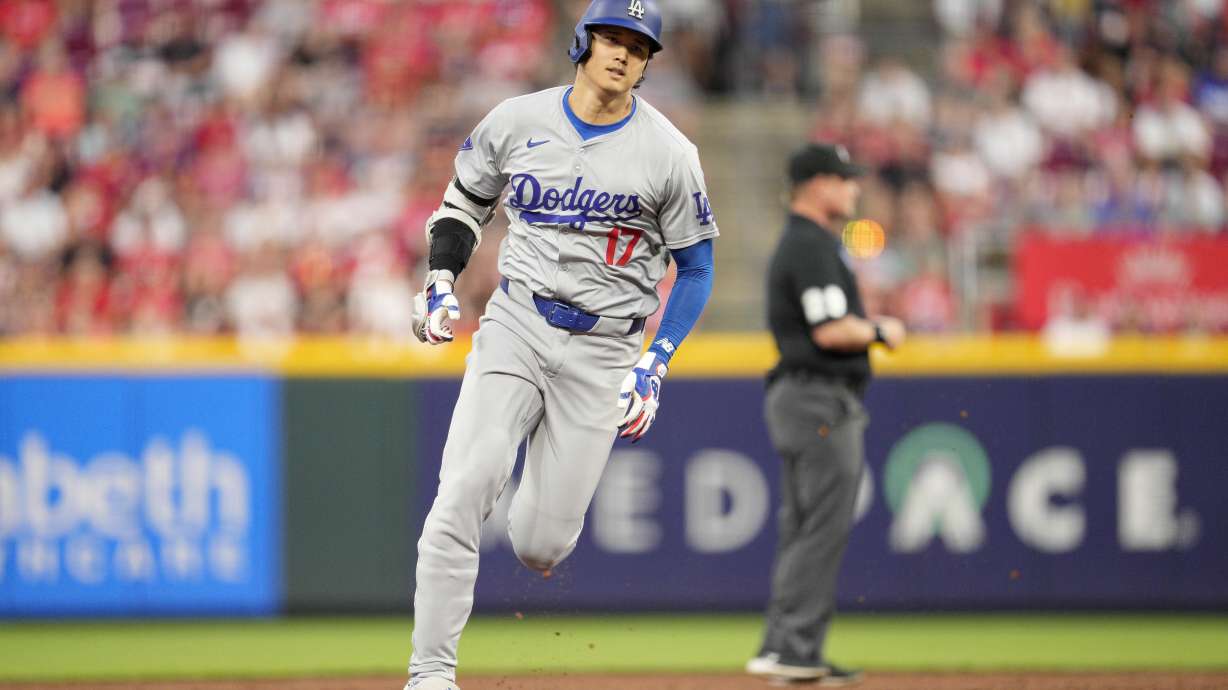 Los Angeles Dodgers' Shohei Ohtani rounds the bases after hitting a triple during the sixth inning of a baseball game against the Cincinnati Reds, Saturday, May 25, 2024, in Cincinnati.