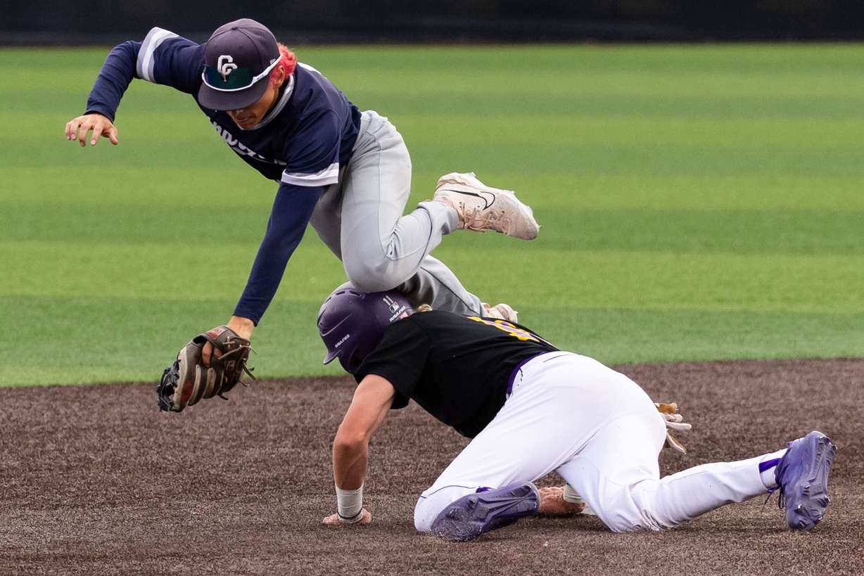 Corner Canyon’s Kash Koncar trips over Lehi’s
Tanner Heaps while trying to catch the ball in the second game for the 6A high school baseball state championship at the UCCU Ballpark in Orem on Saturday, May 25, 2024.