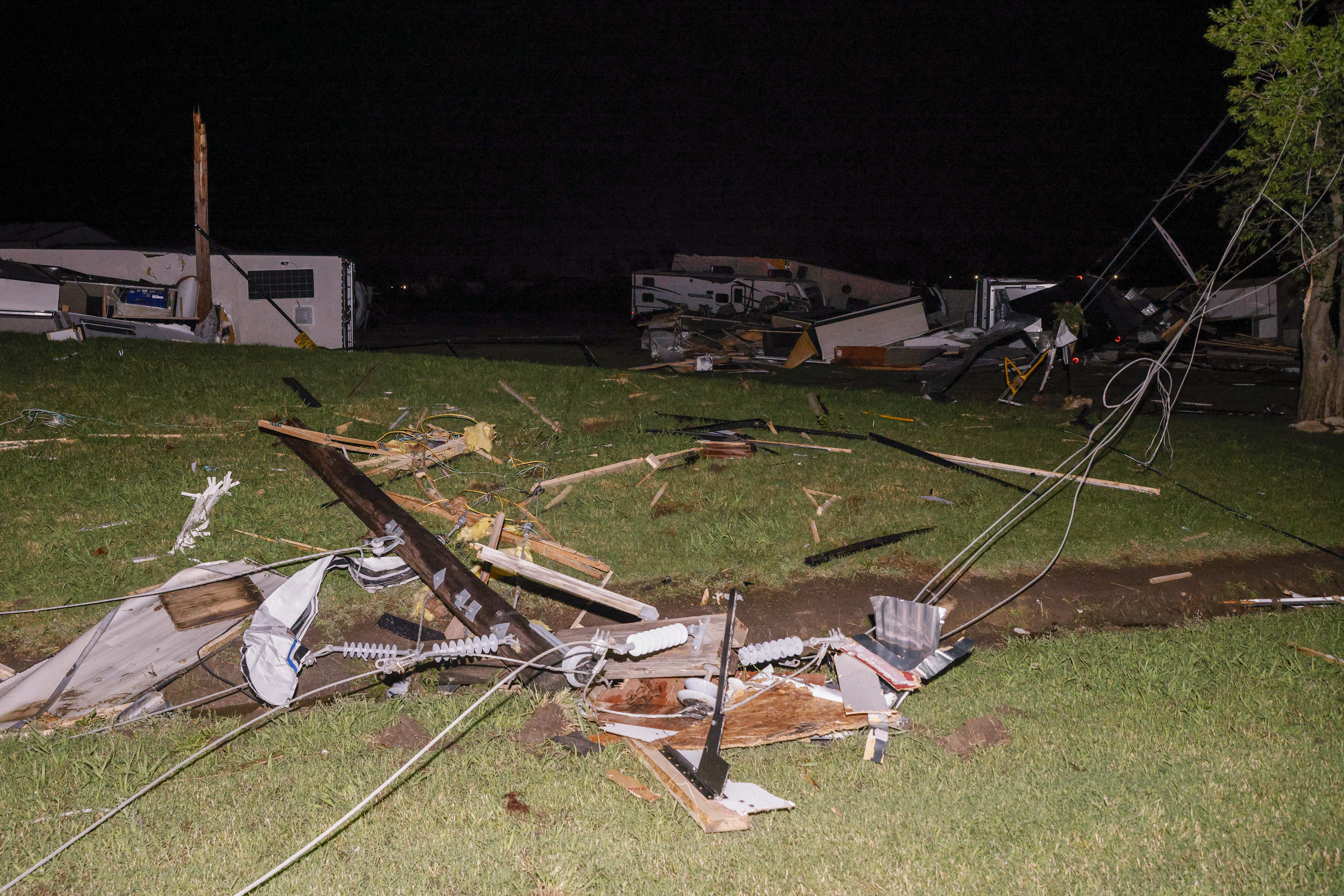 A mangled power line is seen near a recreational vehicle dealership after a suspected tornado moved through the area, Sunday, in Valley View, Texas.