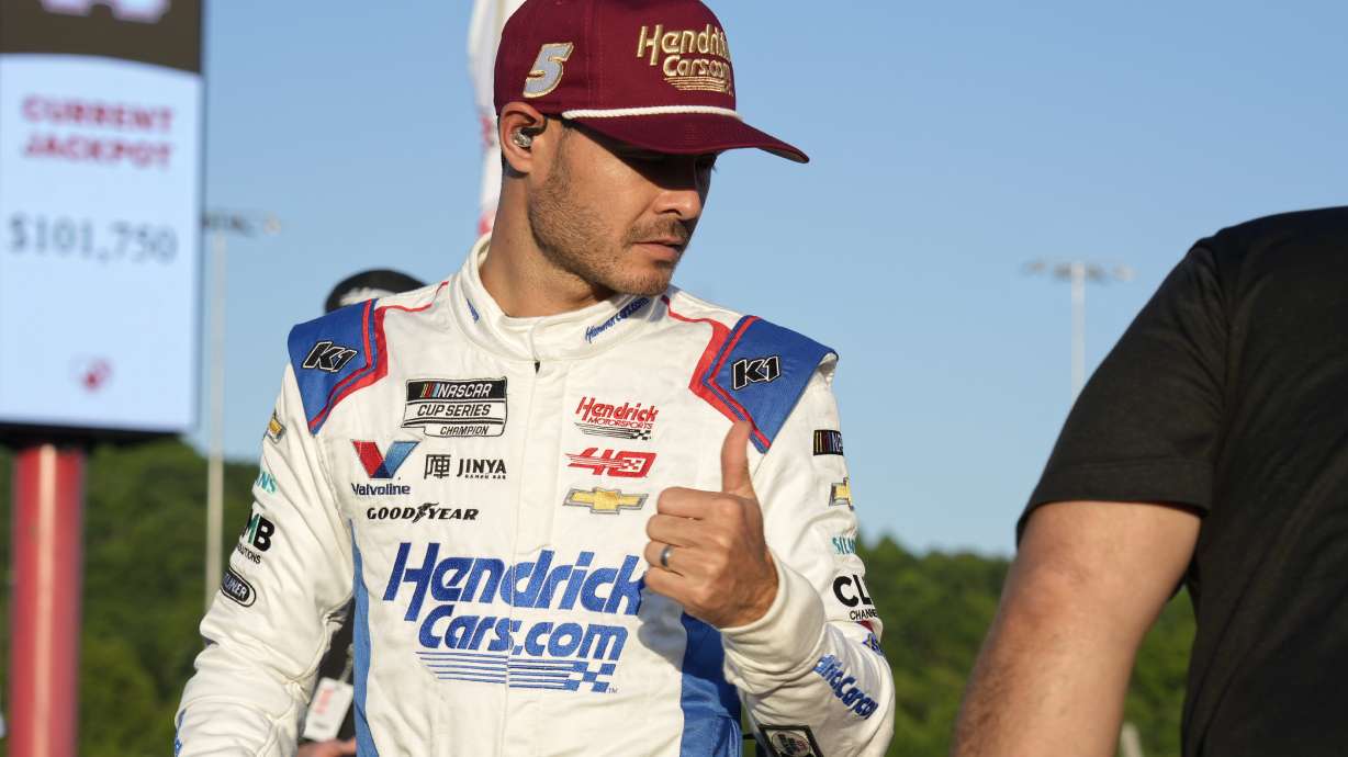 Kyle Larson gives a thumbs-up after arriving for the NASCAR All-Star auto race at North Wilkesboro Speedway in North Wilkesboro, N.C., Sunday, May 19, 2024.