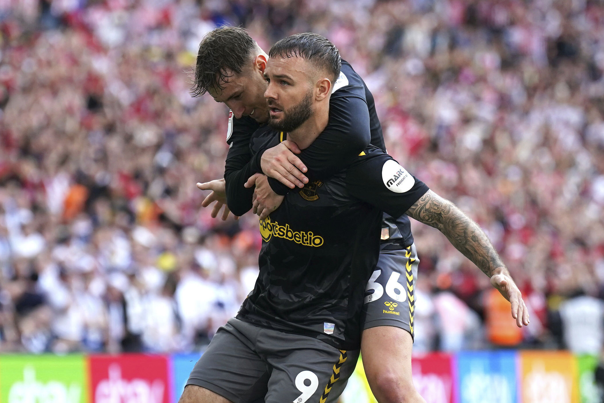 Southampton's Adam Armstrong, front, celebrates scoring during the Championship play-off final between Leeds United and Southampton at Wembley Stadium, London, Sunday May 26, 2024. 