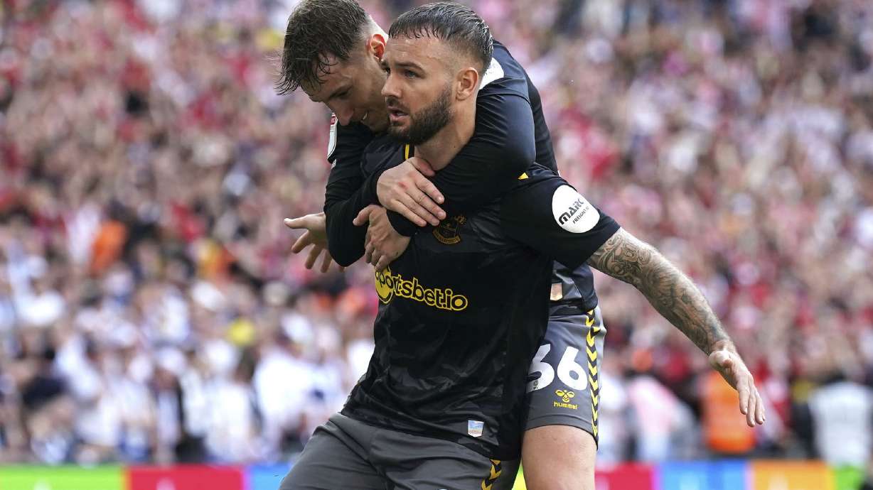 Southampton's Adam Armstrong, front, celebrates scoring during the Championship play-off final between Leeds United and Southampton at Wembley Stadium, London, Sunday May 26, 2024.