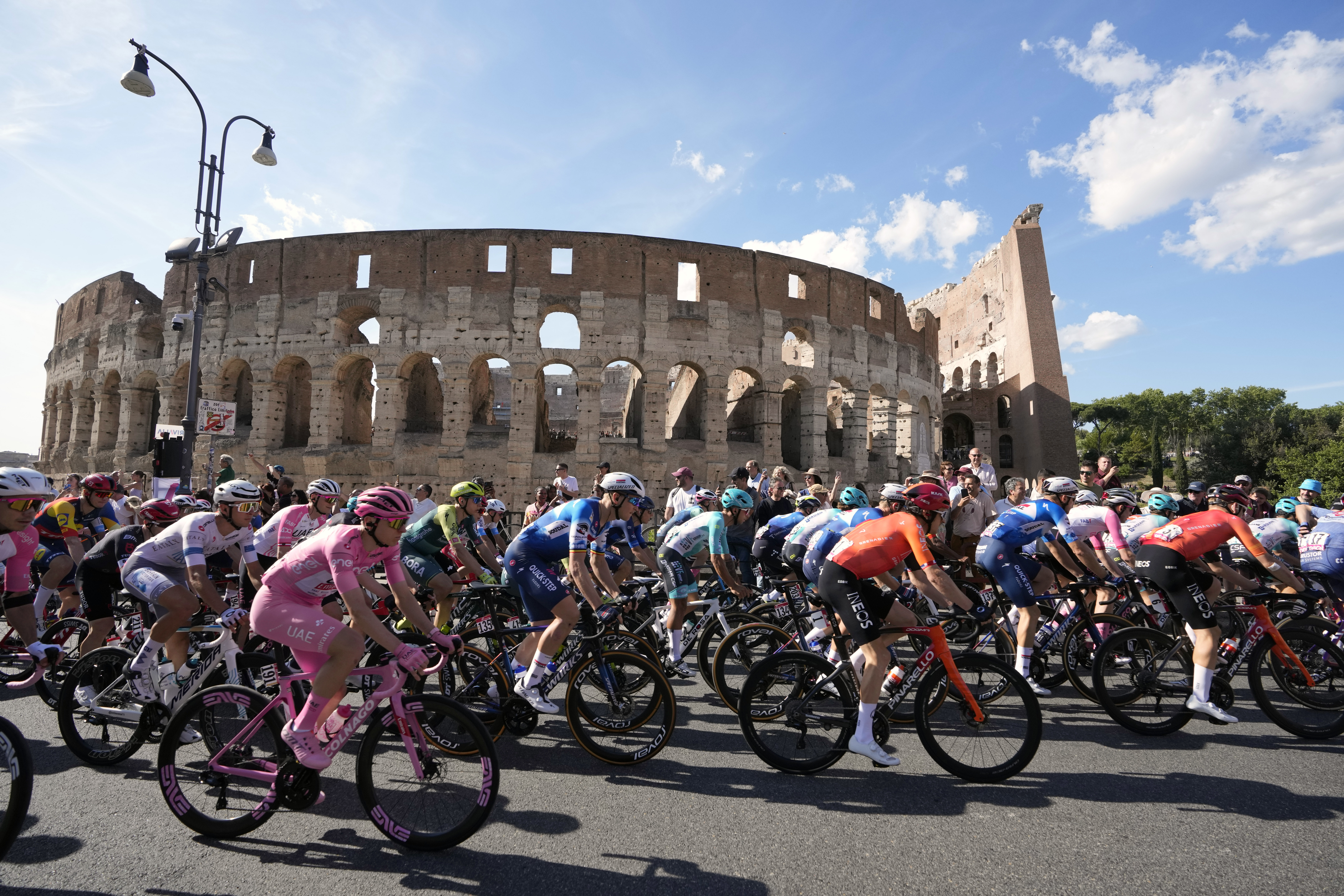 Cyclists, including the pink jersey overall leader Slovenia's Tadej Pogacar, ride past the ancient Colosseum during the final stage of the Giro d'Italia cycling race in Rome, Sunday, May 26, 2024.