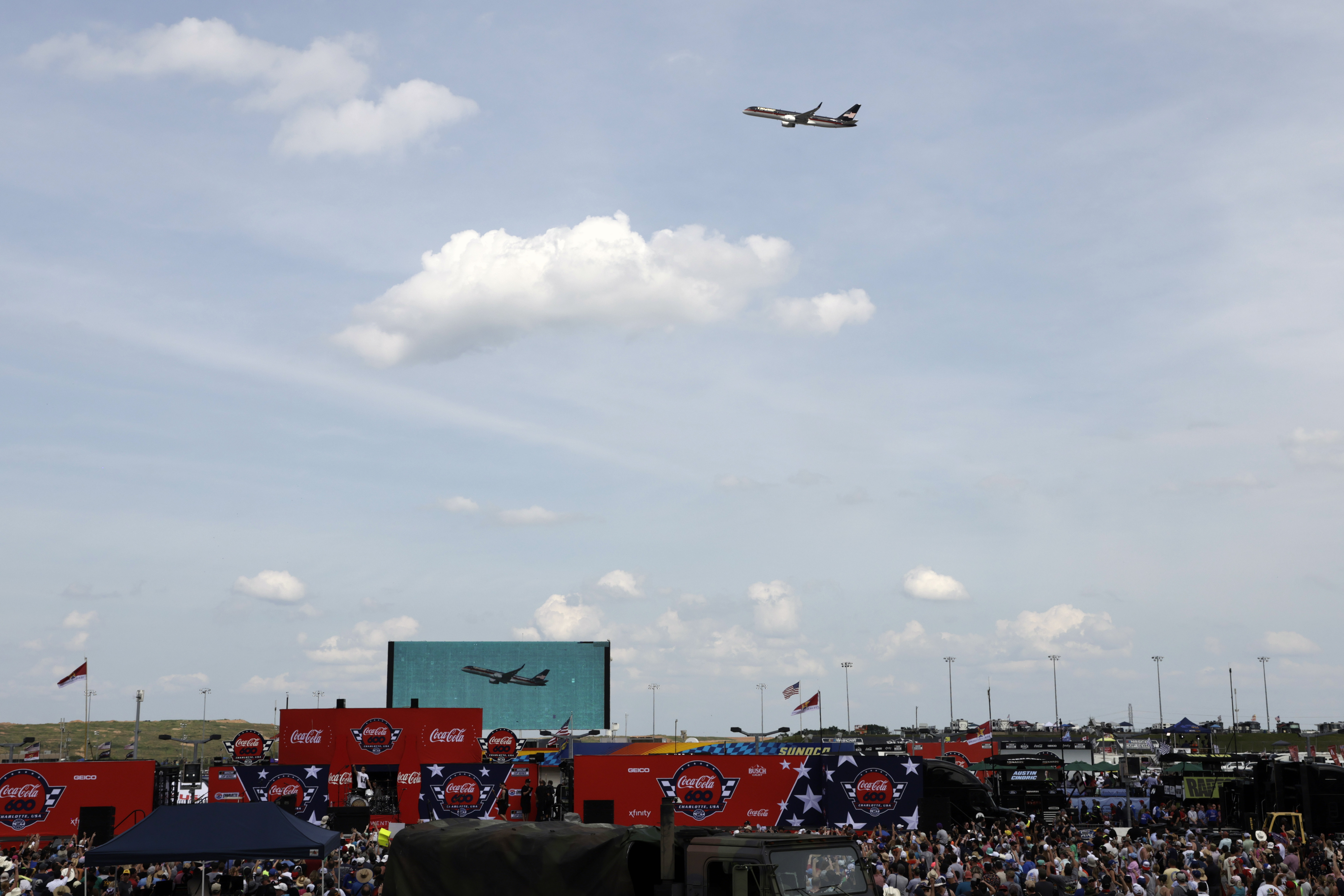 Former President Donald Trump's jet flies over the crowd before he attends the NASCAR Coca-Cola 600 auto race, Sunday, May 26, 2024, in Concord, N.C. It is the first time that a president or former president has attended a race at Charlotte Motor Speedway. 