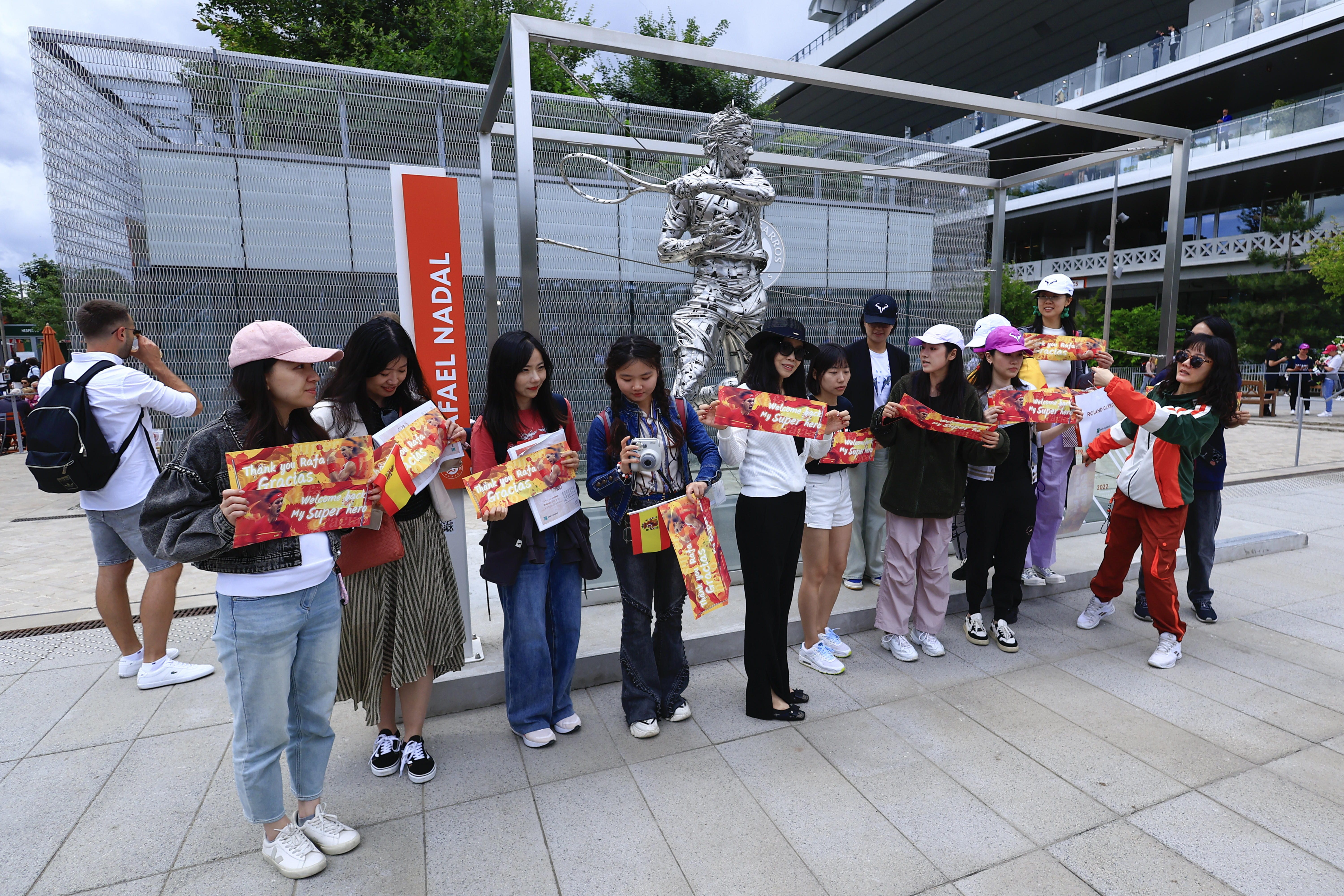 Fans of Spain's Rafael Nadal pose for pictures with his statue ahead of his first round match of the French Open tennis tournament against Germany's Alexander Zverev at the Roland Garros stadium in Paris, Monday, May 27, 2024. 