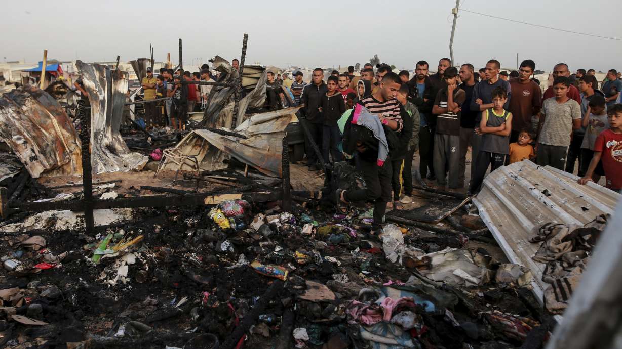 Palestinians look at the destruction after an Israeli strike where displaced people were staying in Rafah, Gaza Strip, Monday. Palestinian health workers said Israeli airstrikes killed at least 35 people in the area.